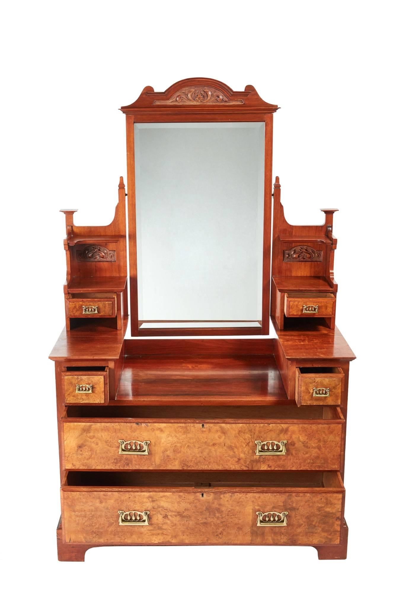 Antique burr walnut dressing chest, with a shaped tilting mirror carving to the top, lovely carved supports with drawers, unusual brass handles, the base having two short drawers and two long drawers in fantastic burr walnut with unusual brass