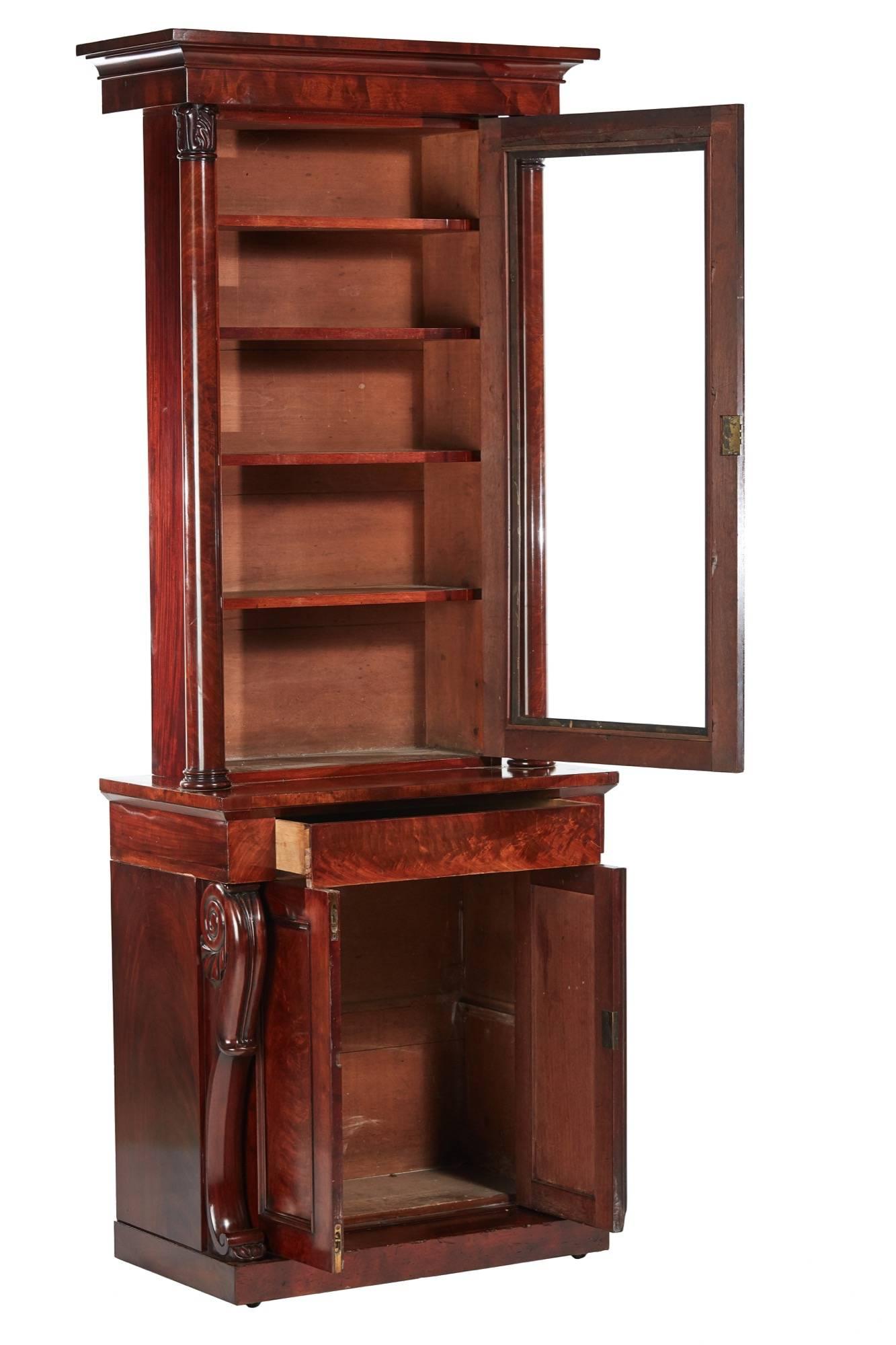 Quality William IV mahogany bookcase, the upper section having a shaped cornice, one single glazed door opens to reveal four adjustable shelves. Lovely carved turned columns, the base having one frieze drawer, two doors and fantastic carved shaped