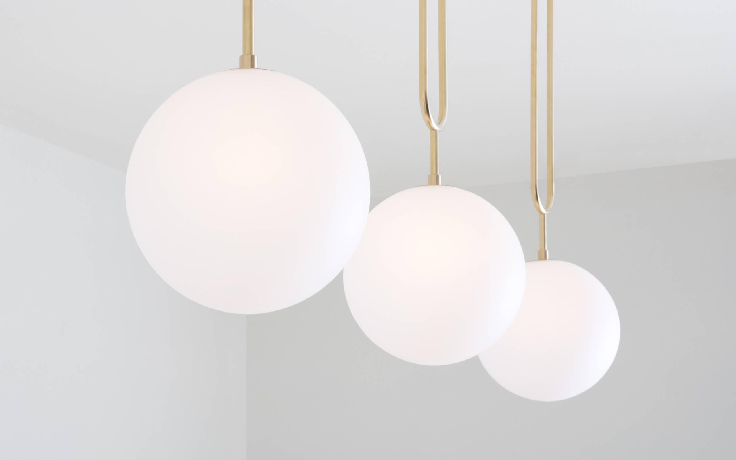 Contemporary Koko, a Modern Pendant Light with Satin Globe Shade in Brushed Brass Finish