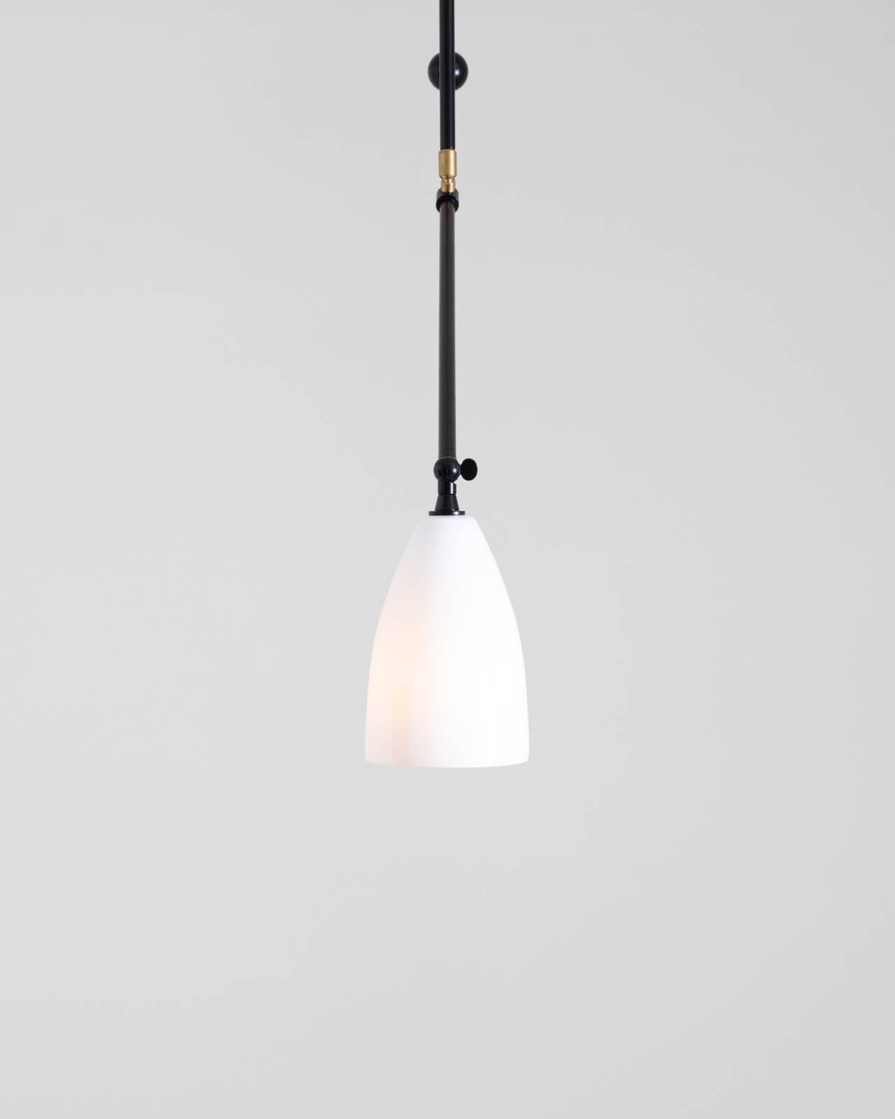 American Slope, A Black Adjustable Task Light with White Glass Shade and Brass Details