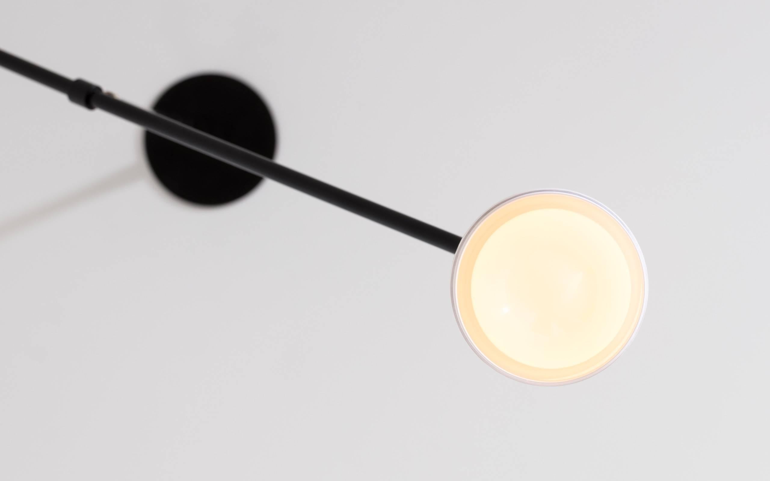 Mid-Century Modern Slope, A Black Adjustable Task Light with White Glass Shade and Brass Details