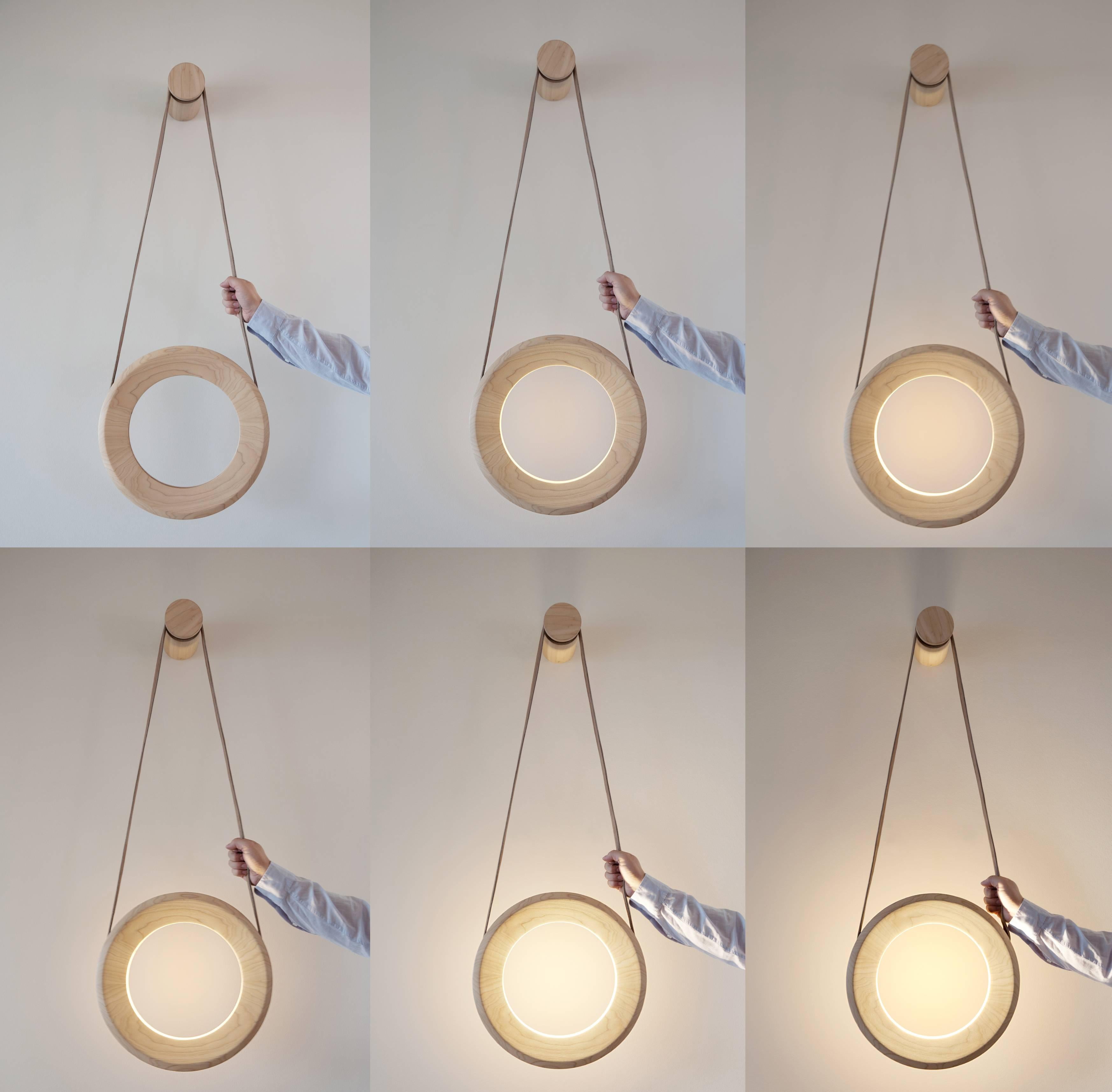 Halo lamp is award winning wall lamp designed to create a new and interesting link between the lamp and its user. There are no visible controls such as dimmer or a switch but instead they are integrated into the lamp itself. This means that in order