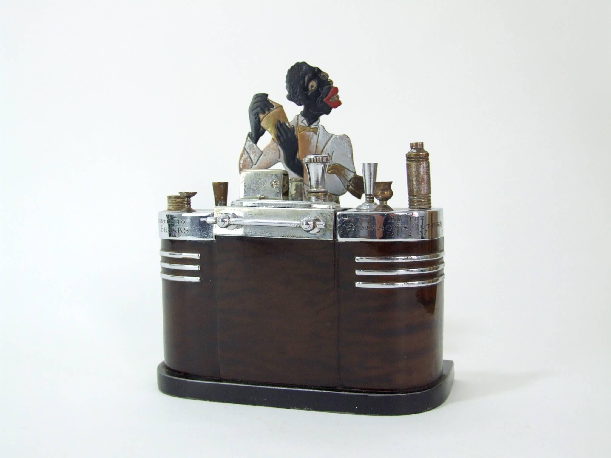 An original and now rare Ronson Touch Tip bartender lighter and cigarette box. Black patinated metal base, wood effect bar and chrome detailing. It bears a presentation inscription which is dated 1937. The lighter in the centre section has its