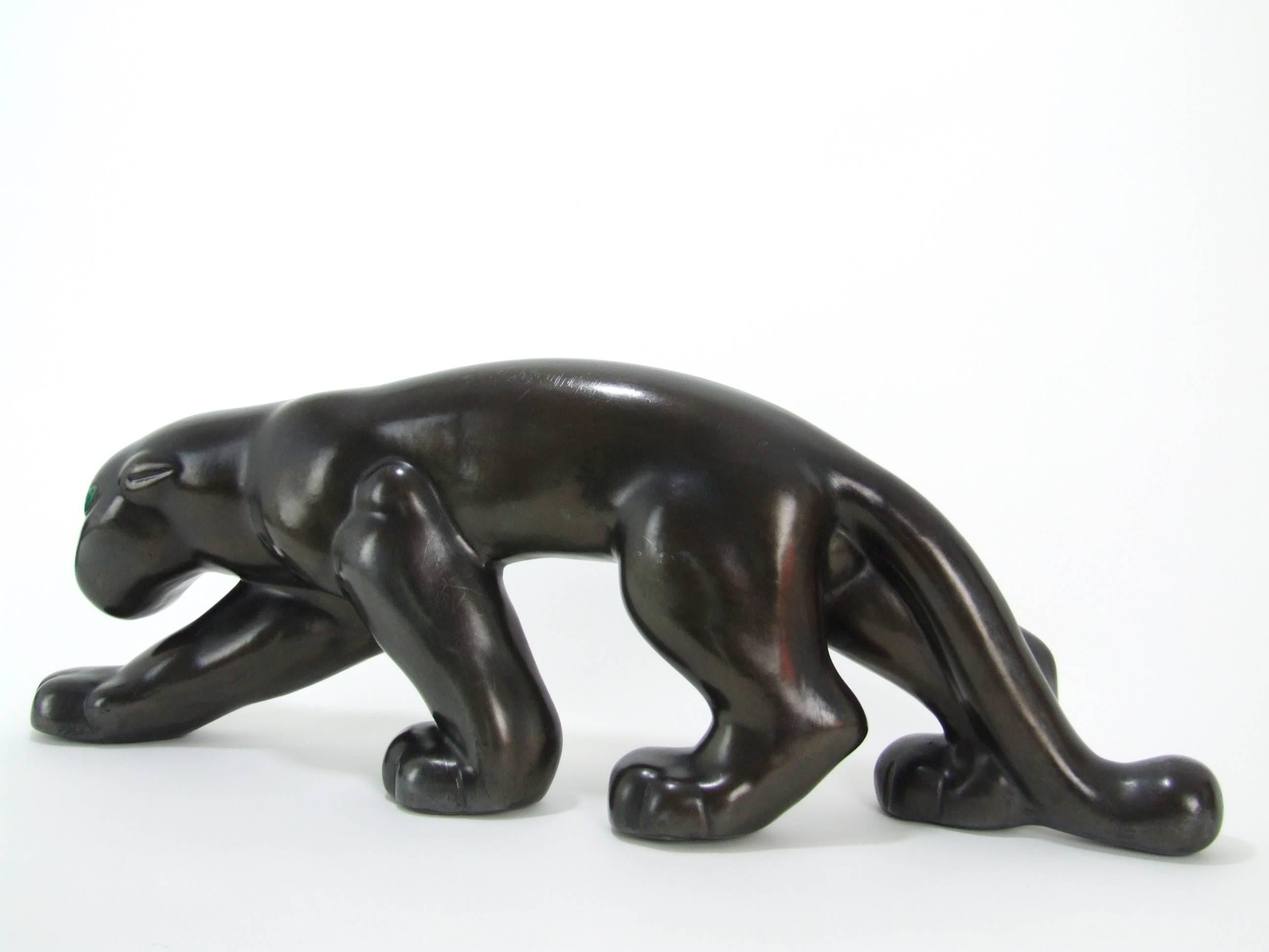 A large and original ceramic panther made by the Primavera Atelier and featured in the Les Craqueles Art Deco book. He measures 59cm (23.25 inches) long and is in very good vintage condition. He has a very dark, but not black finish with tones of