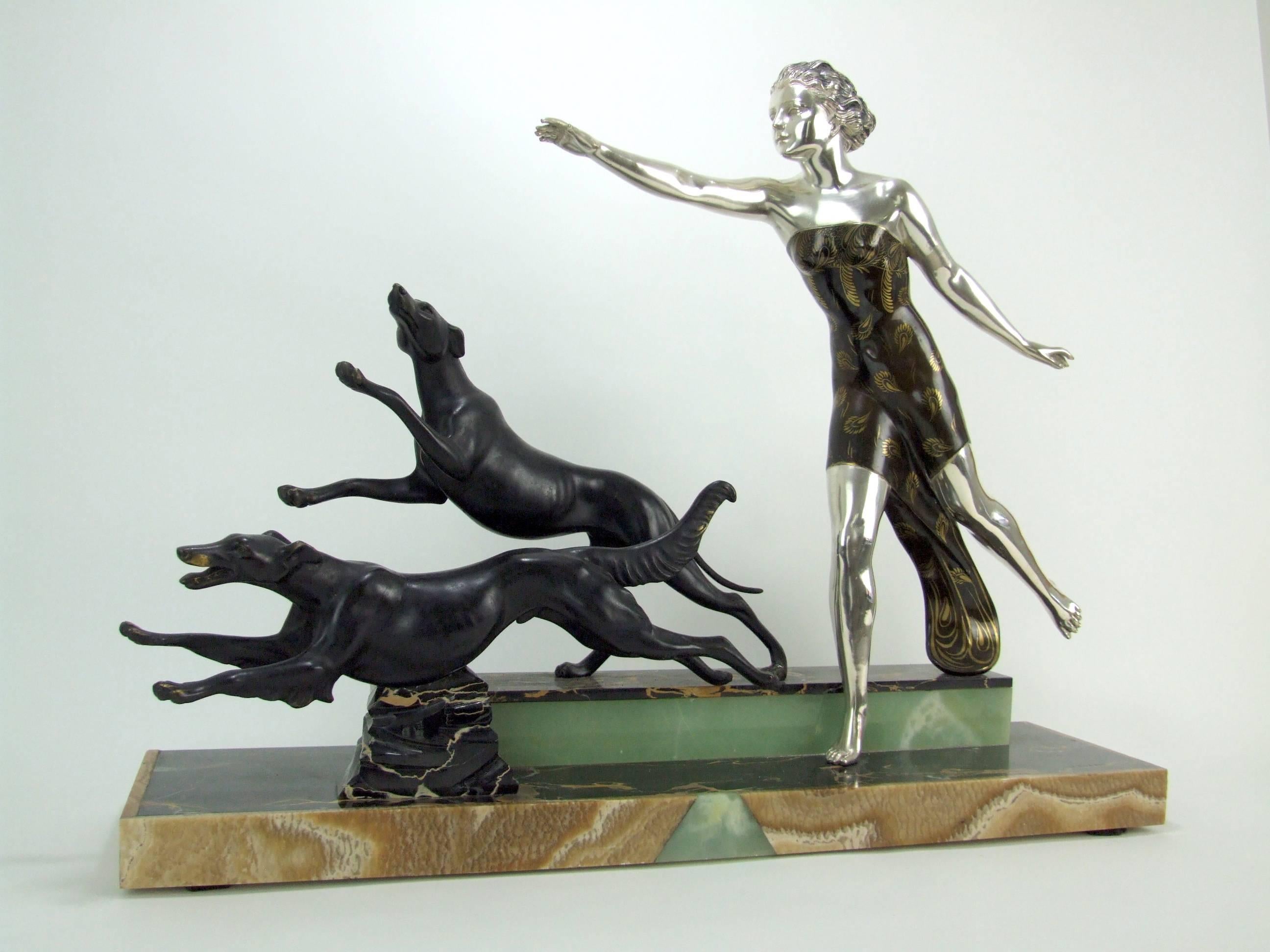 A French spelter, marble and onyx Art Deco group made, circa 1925 and signed by the artist Uriano. Uriano is a pseudonym used by Ugo Cipriani. She is a depiction of Diana the Huntress with dogs. Mounted on a base of portorro marble and brown and