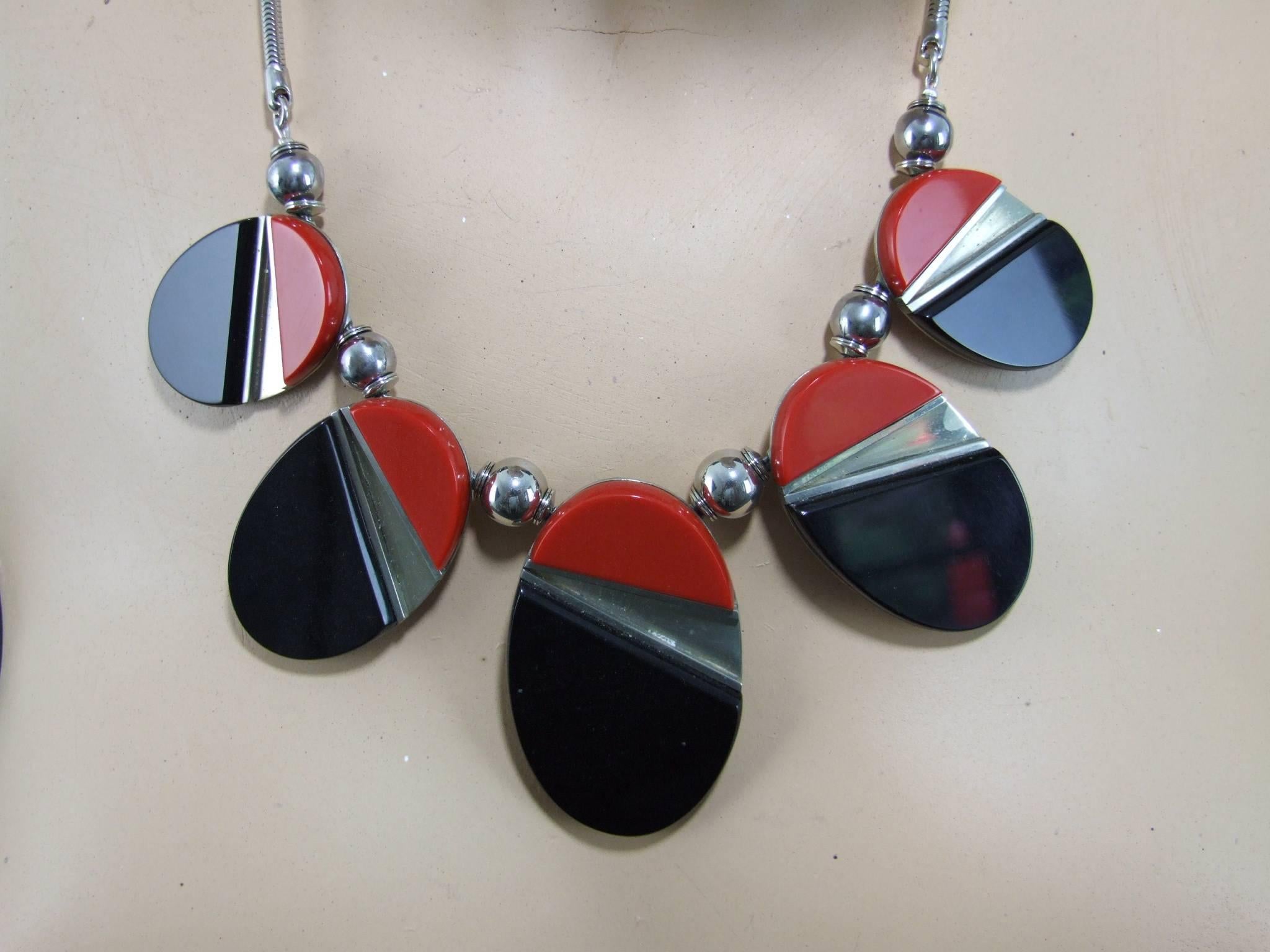 Large modernist red and black galalith and chromed metal necklace by Jakob Bengal. The central panel measures a late 2.5 inches high by 1.5 inches wide (6.5cm x 4cm). The total length from clasp to clasp is 19.5 inches (50cm). Condition is very good