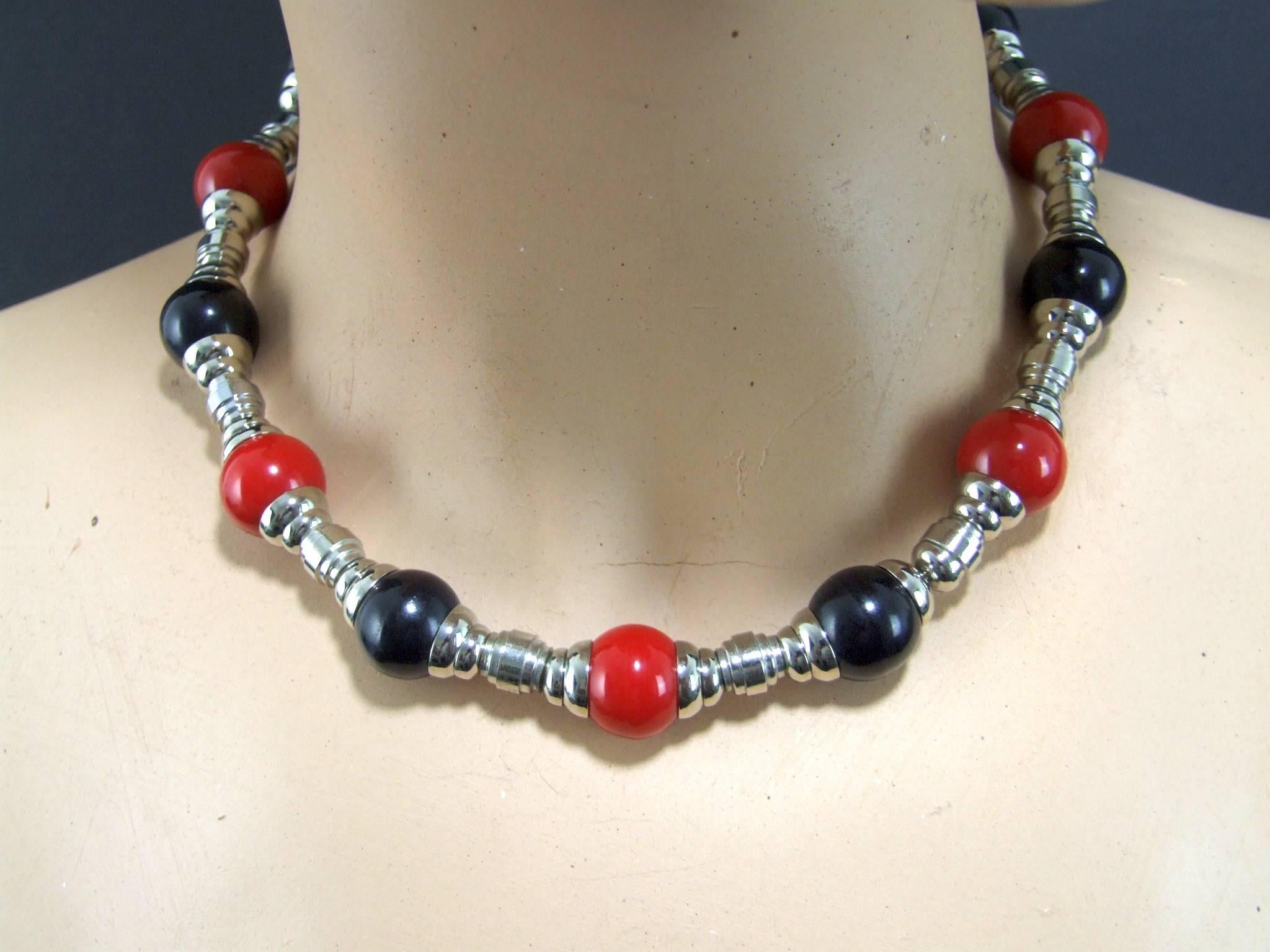 1930s chrome metal and red and black galalith Art Deco necklace. It measures 16 inches from clasp to clasp. Condition is extremely good as it is an old unsold stock item. Similar necklaces to this can be viewed in the Jakob Bengal books.