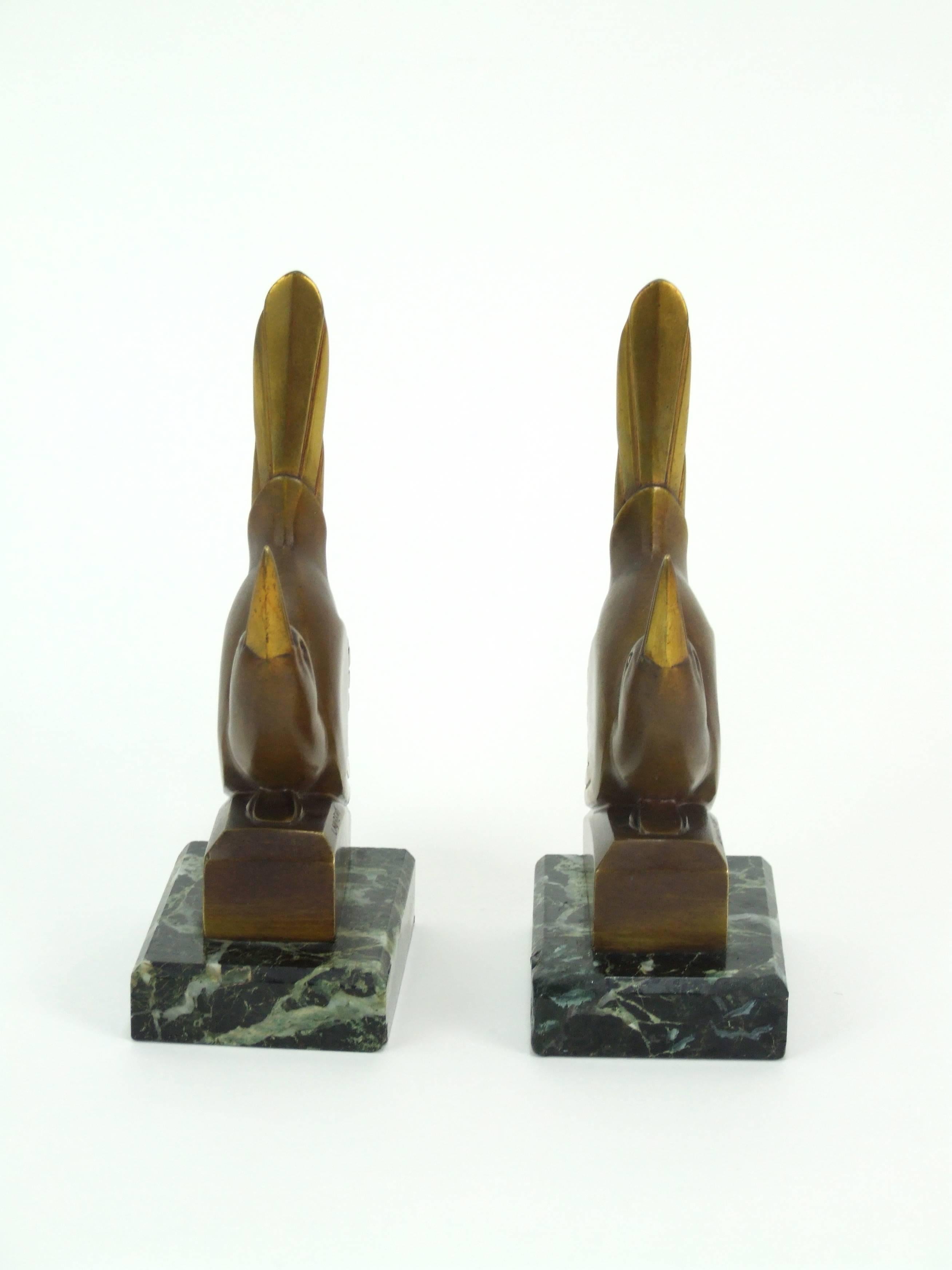 French Art Deco bronze stylised bird bookends by Laurent. Signed to the base and stamped with the Etling foundry mark. They each measure 7 inches high by 3 inches wide by 2.5 inches deep (17.5 cm x 7.5 cm x 6.5 cm). In good condition with some old