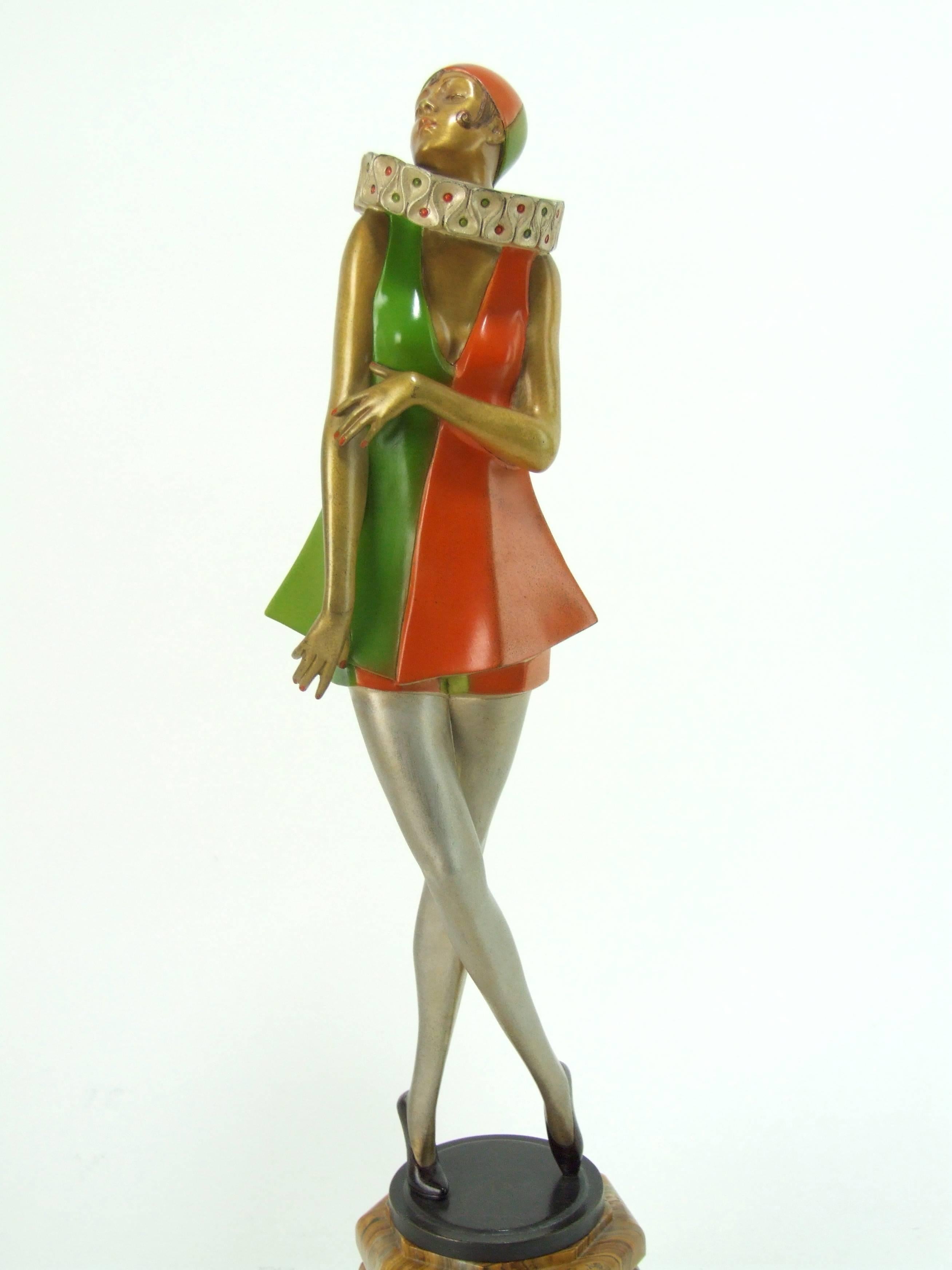 Large and rare bronze art deco harlequin dancer by Josef Lorenzl, circa 1925 and signed in the bronze. Original orange and green enamelling to her costume. Mounted on a raised faceted stepped onyx base. It measures a large 18 inches high (45.5cm).