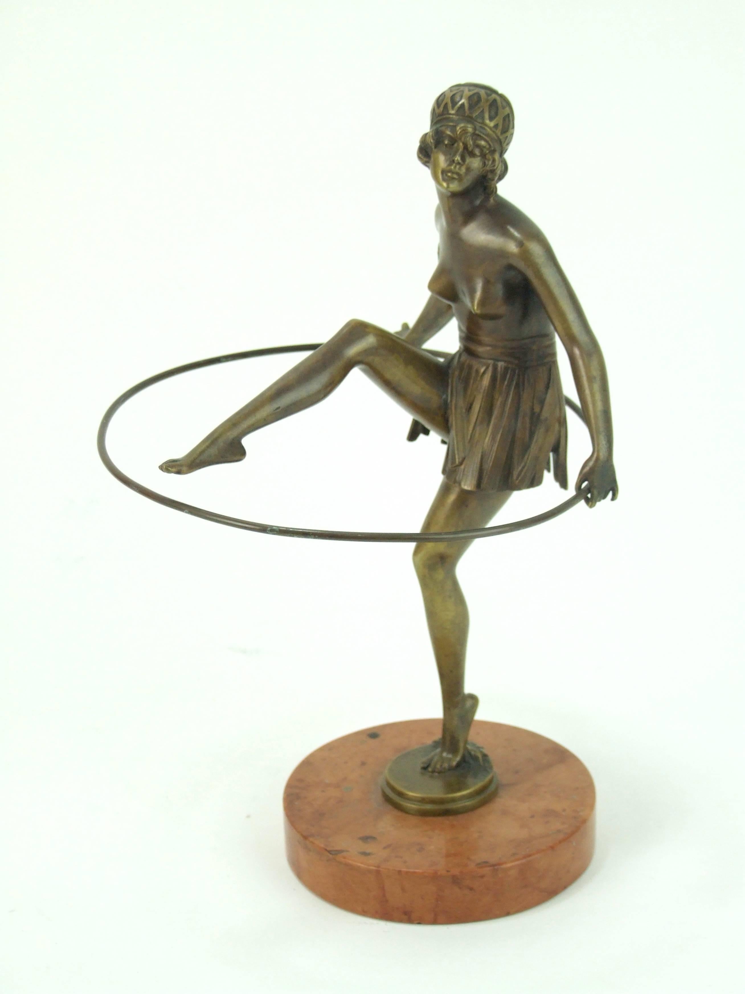 Art Deco bronze dancer by Bruno Zach, signed in the bronze base, circa 1925. Mounted on a circular marble base, she measures 11 inches high (28cm). Condition is vintage but very good.