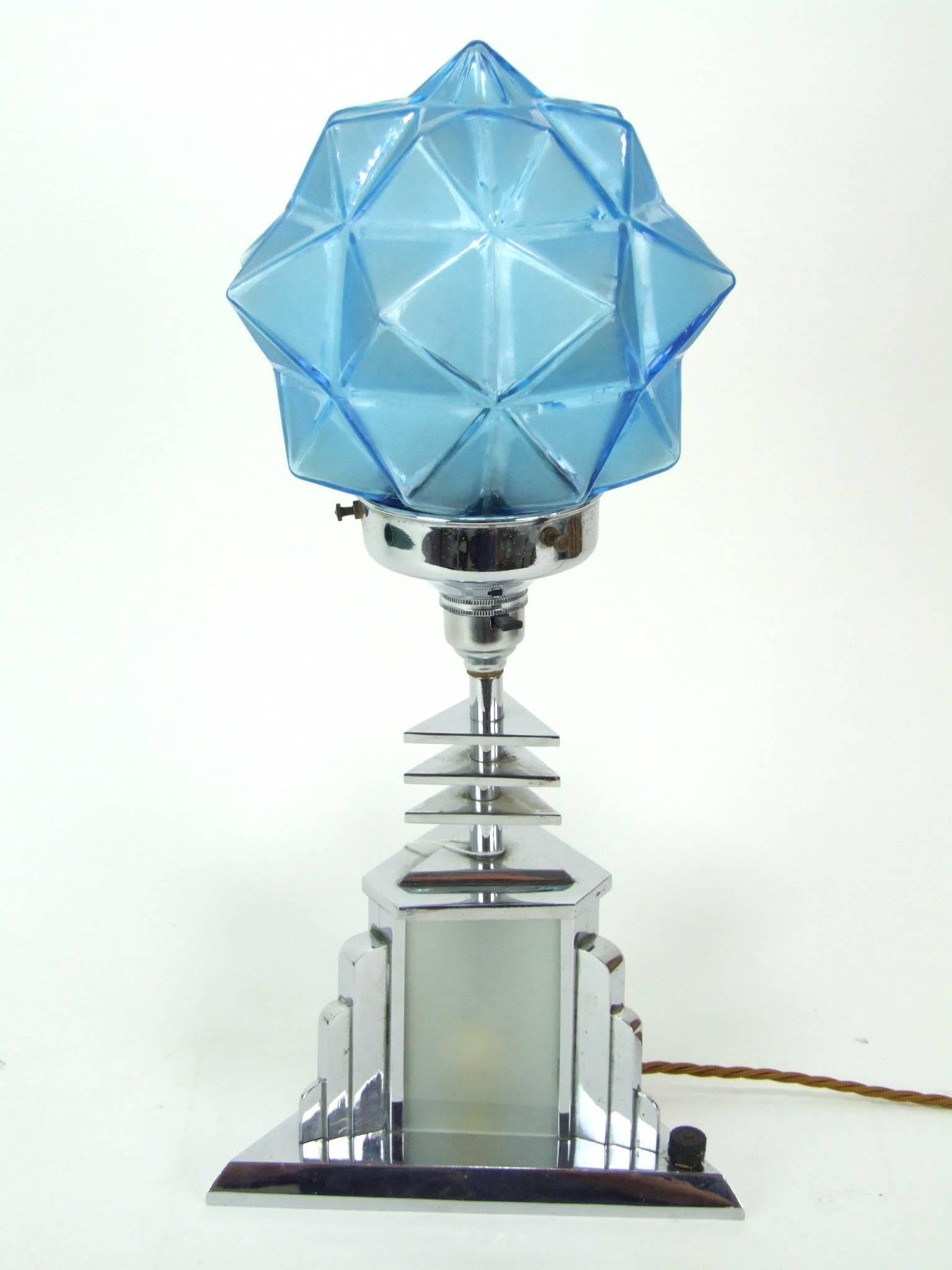 Top quality Adnet style triangle and star Art Deco shade table lamp. Blue glass star shade that lights up and also has a bulb in the base glazed section. It measures 8 inches to each side of the base (20cm) and 17 inches high (43cm). In excellent