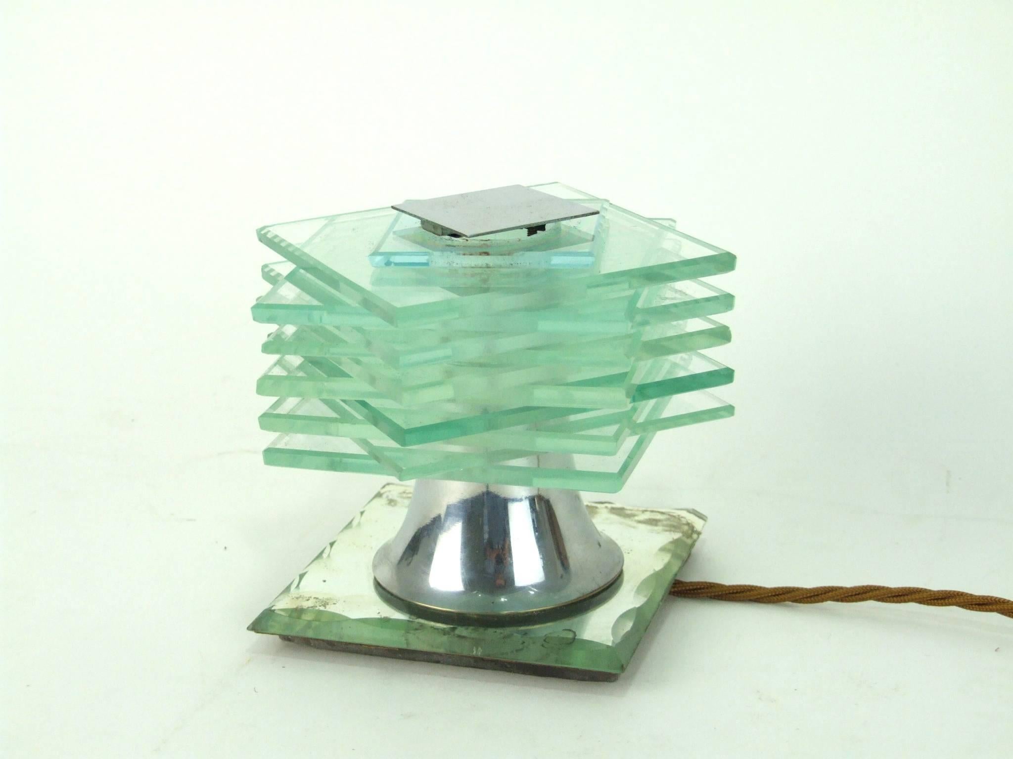 French Art Deco modernist stacked glass table lamp by Desny. It measures 4.5 inches high by 5.5 inches square (11.5cm x 14cm). Condition is good with no chips to the edges of the glass points but there is some foxing and loss of silvering to the