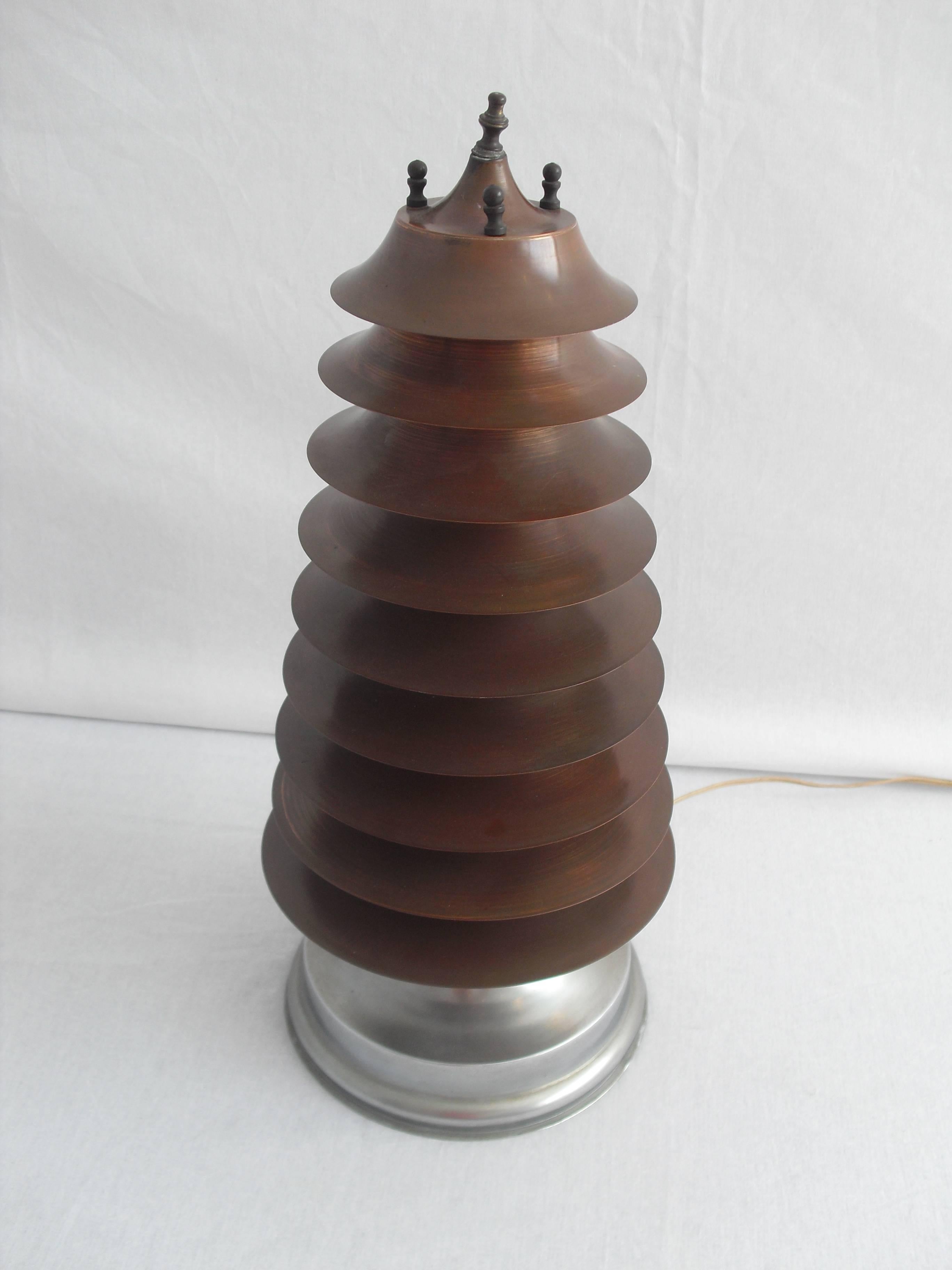 This very rare nine-tier large copper table lamp is made during the Art-Deco period.

The only information we have about it, is that it came from an old couple who collected all kinds of design furniture and art, from all over the world.

We