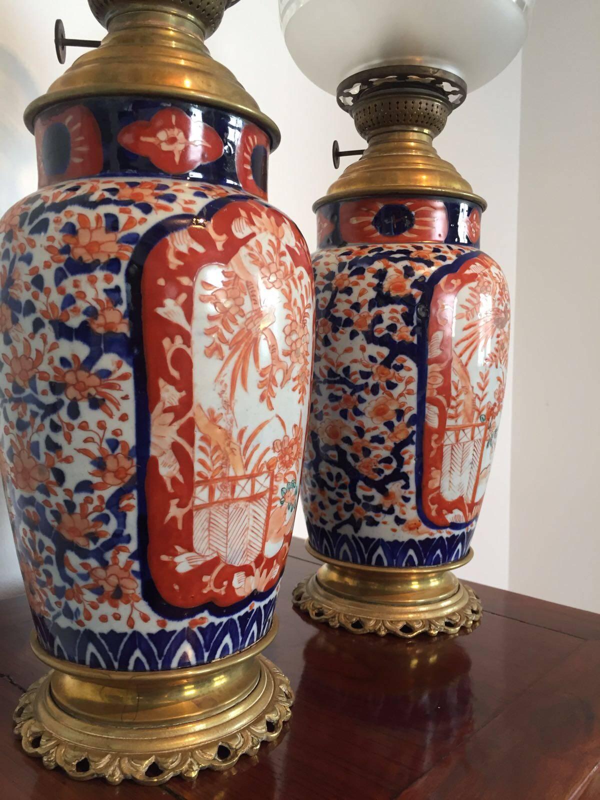 These antique Japanese porcelain oil lamps were made during the Edo (Tokugawa) era, circa 1825.
Hand-painted Ko Imari decoration in bright blue and red.
Finished with brass base and torch.
All (glass) parts are still original and has no damage,