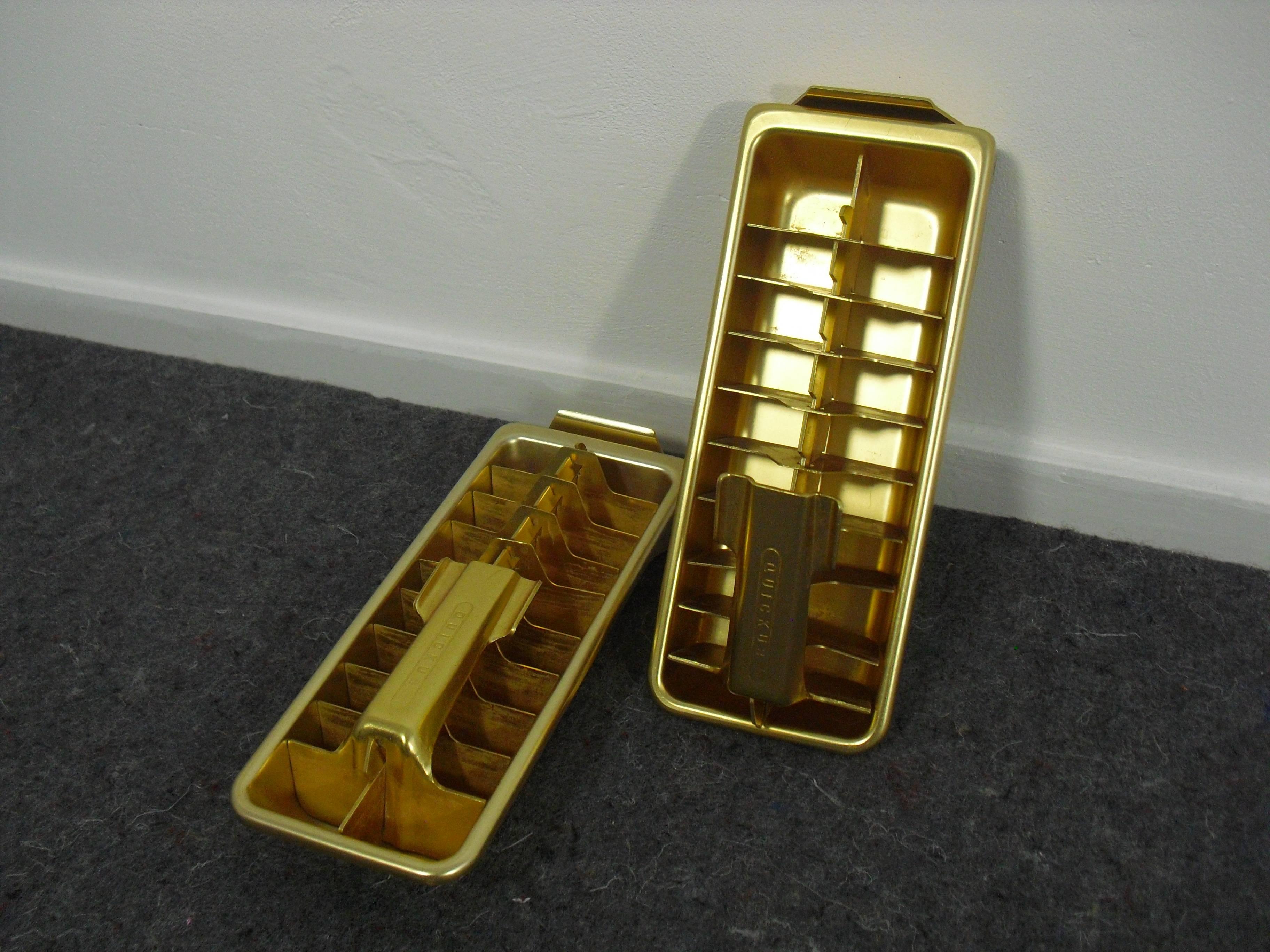 Stunning pair of Brass / Gold colored metal Ice Cube Tray's by 'Quick Ice' 

Designed by American engineer Edward Roberts during the 1950's.

Enclosed engeneer drawings and advertisement from the fifties.

Dimensions: L 28 cm x W 11,5 cm x H 4