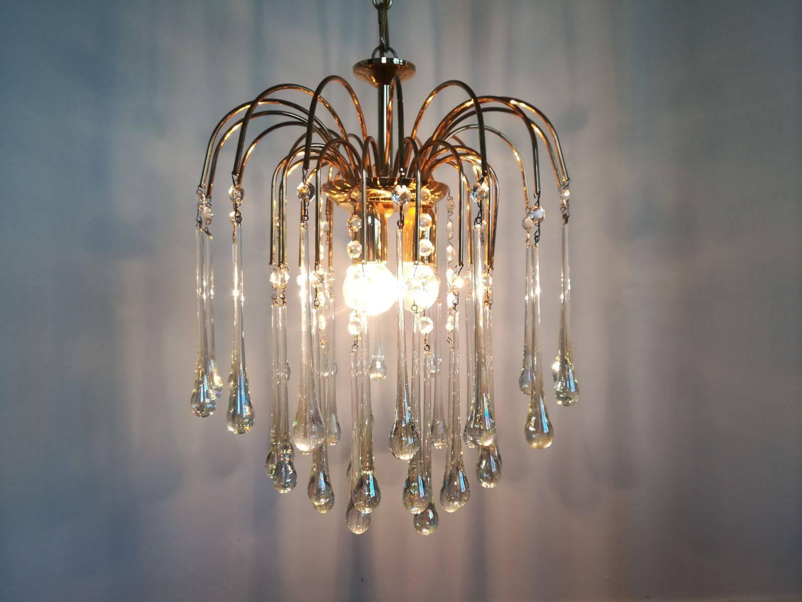 Stunning Venini 'teardrop' chandelier made of 32 crystal clear handmade Murano glass droplets and ice crystals hung on a brass frame.

It's like a fountain of lighted teardrops coming down on you.

Measurements: Height from bottom to ceiling 46