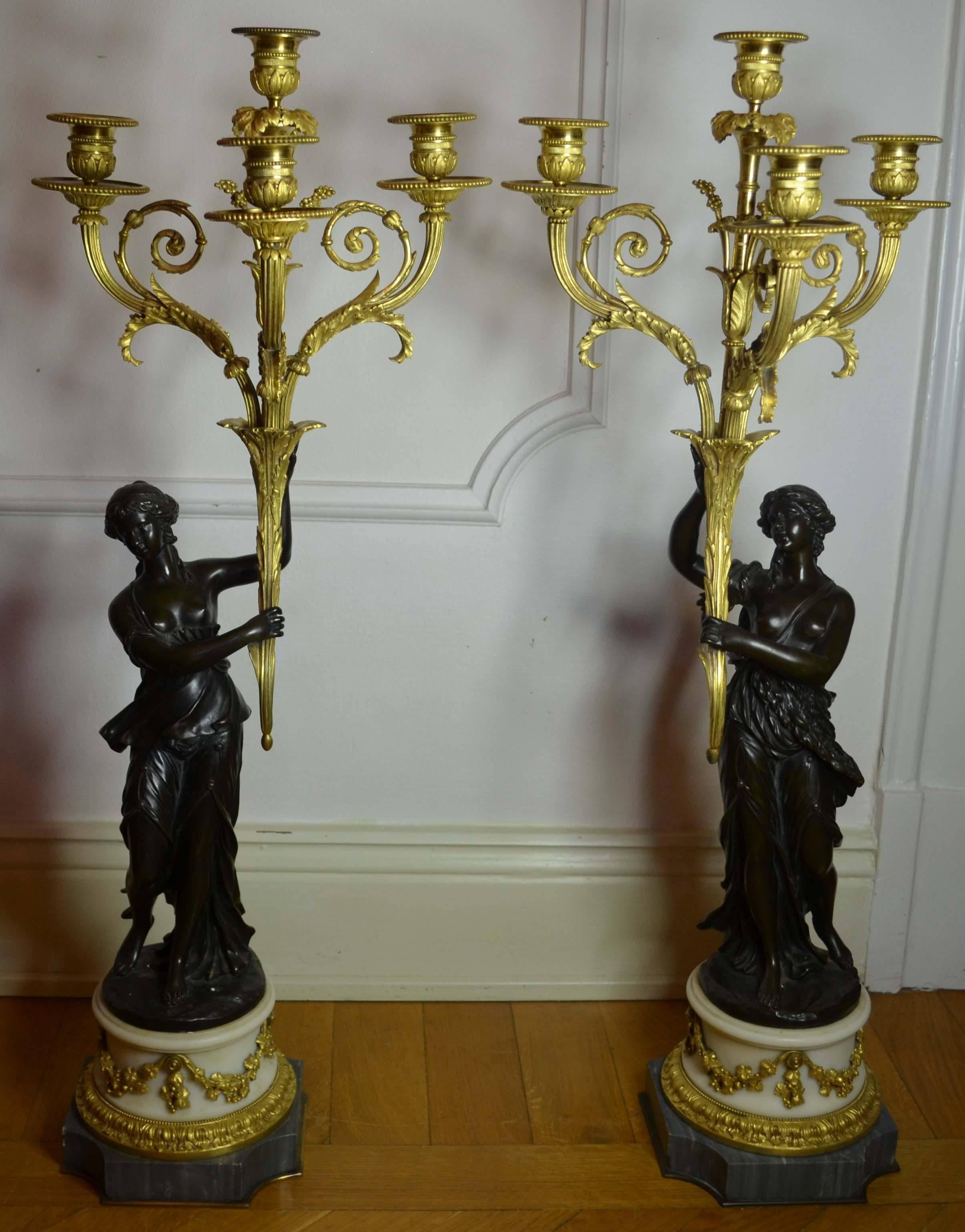 A pair of Louis XVI gilt bronze candelabra with marble and blue turquin base
attributed to Jean-Joseph Foucou.