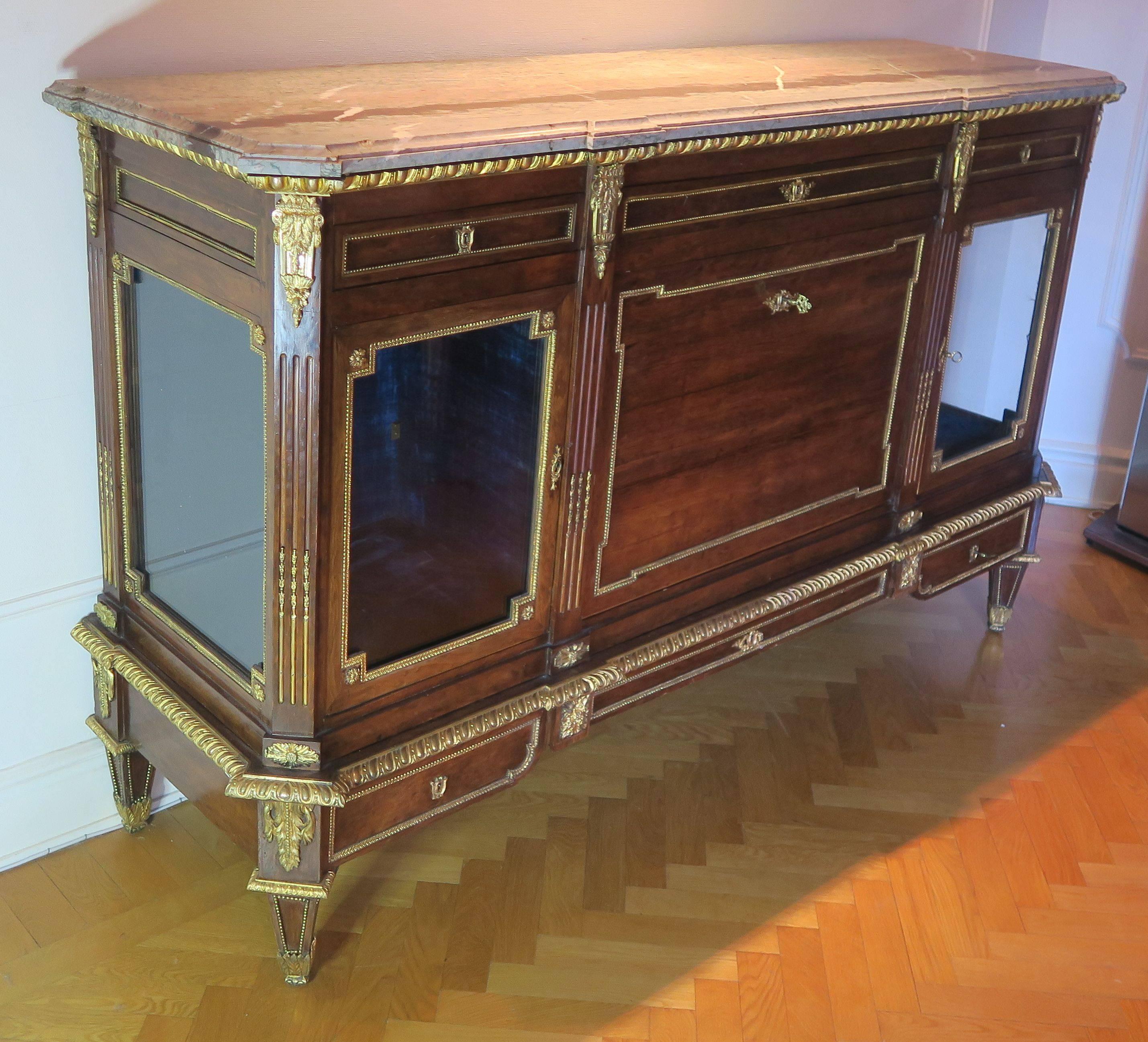 A solid mahogany commode, with gilt bronze mounts and original marble top, attributed Jean-Henri Riesener.