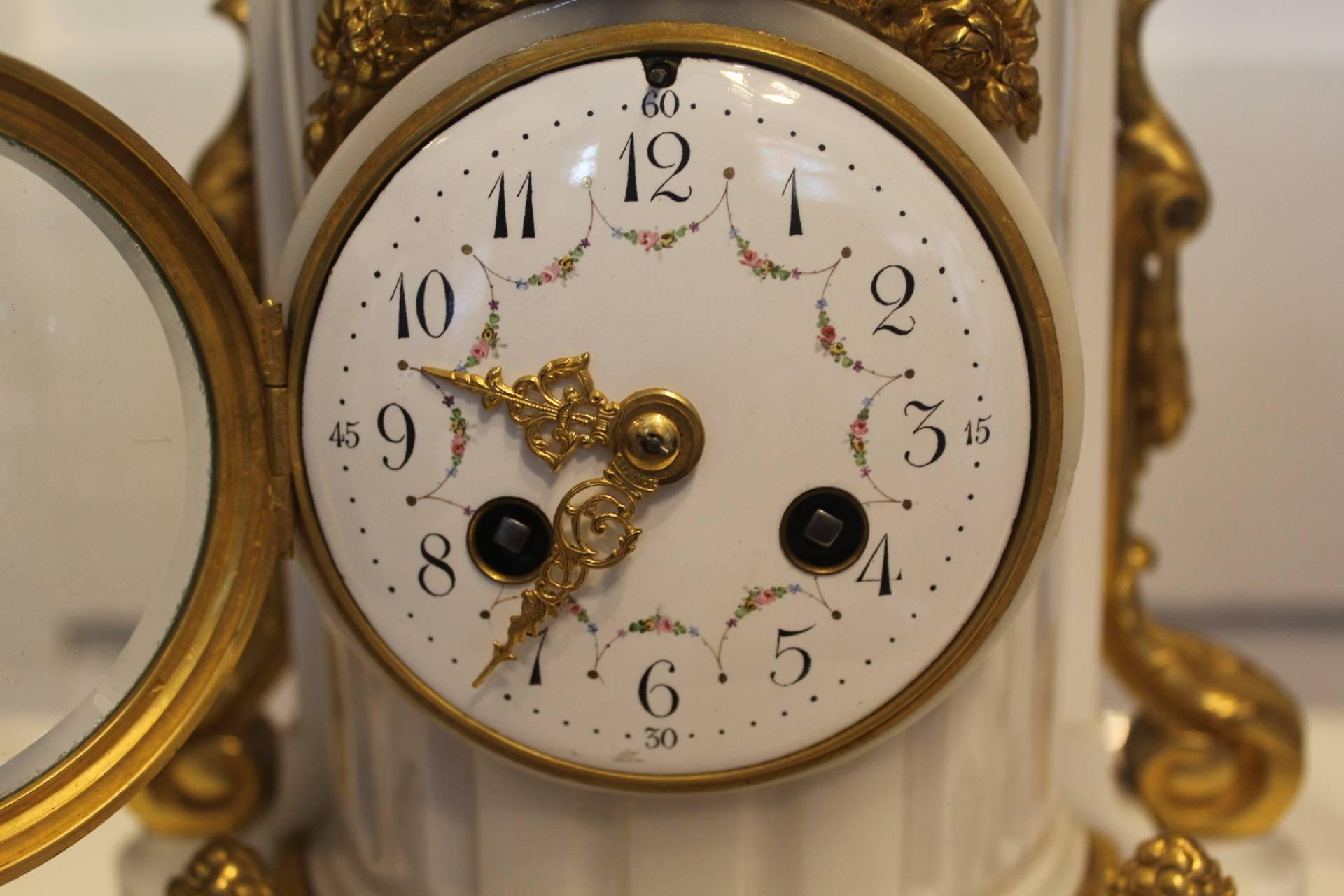 Beautiful white marble clock set by A.D.Mougin, Paris, circa 1900

This three-piece clock set is in wonderful condition with elegant ormolu mounts featuring ribbons, rose garlands, delicate beading and pineapples. The clock is surmounted by two