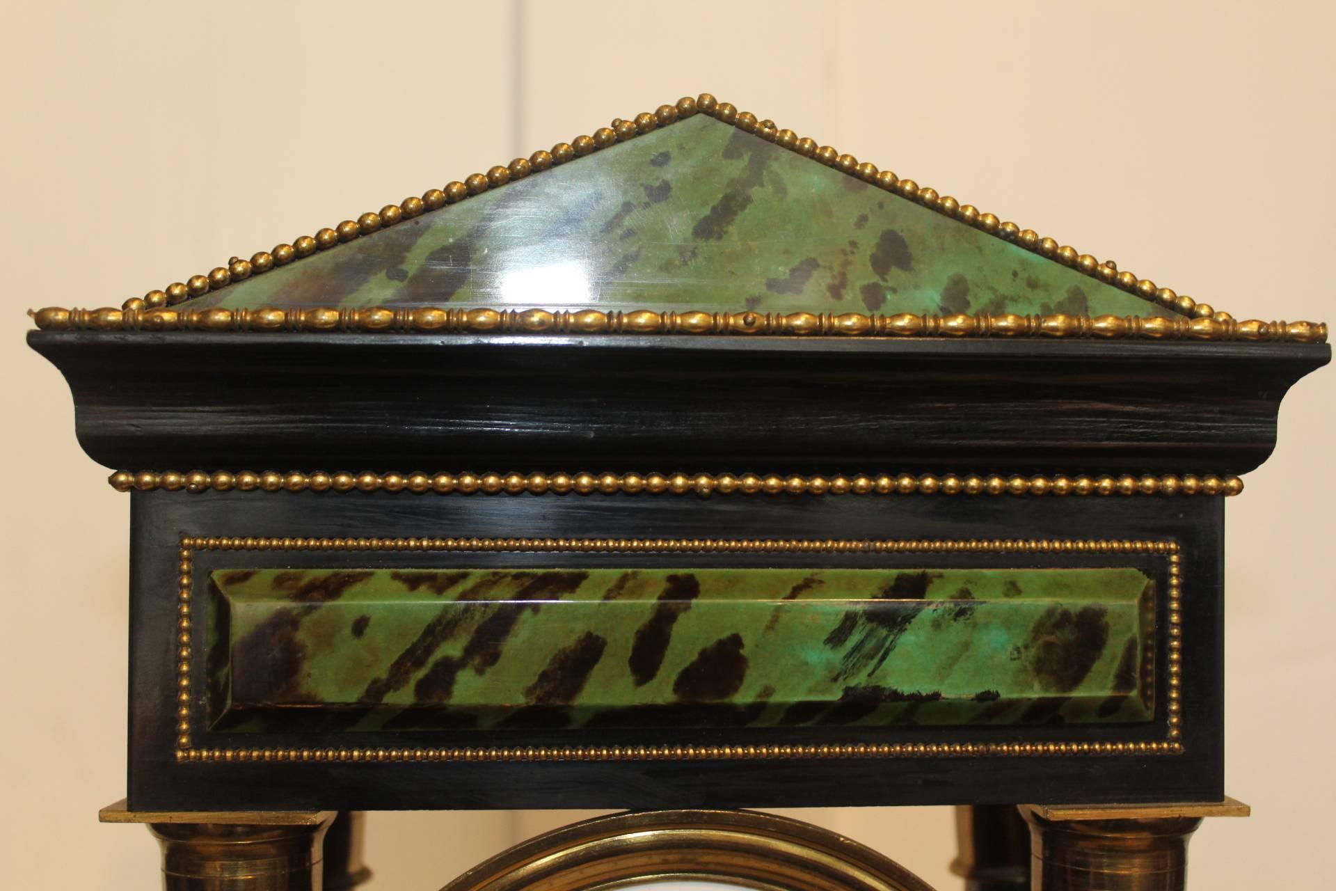 French, ebonized timber portico clock by Eugene Williez, Aix en Provence, circa 1845

Wonderful painted detailing on this faux marble portico clock. The green colouring complimenting the ebonised timber and intact brass beading. The barley twist