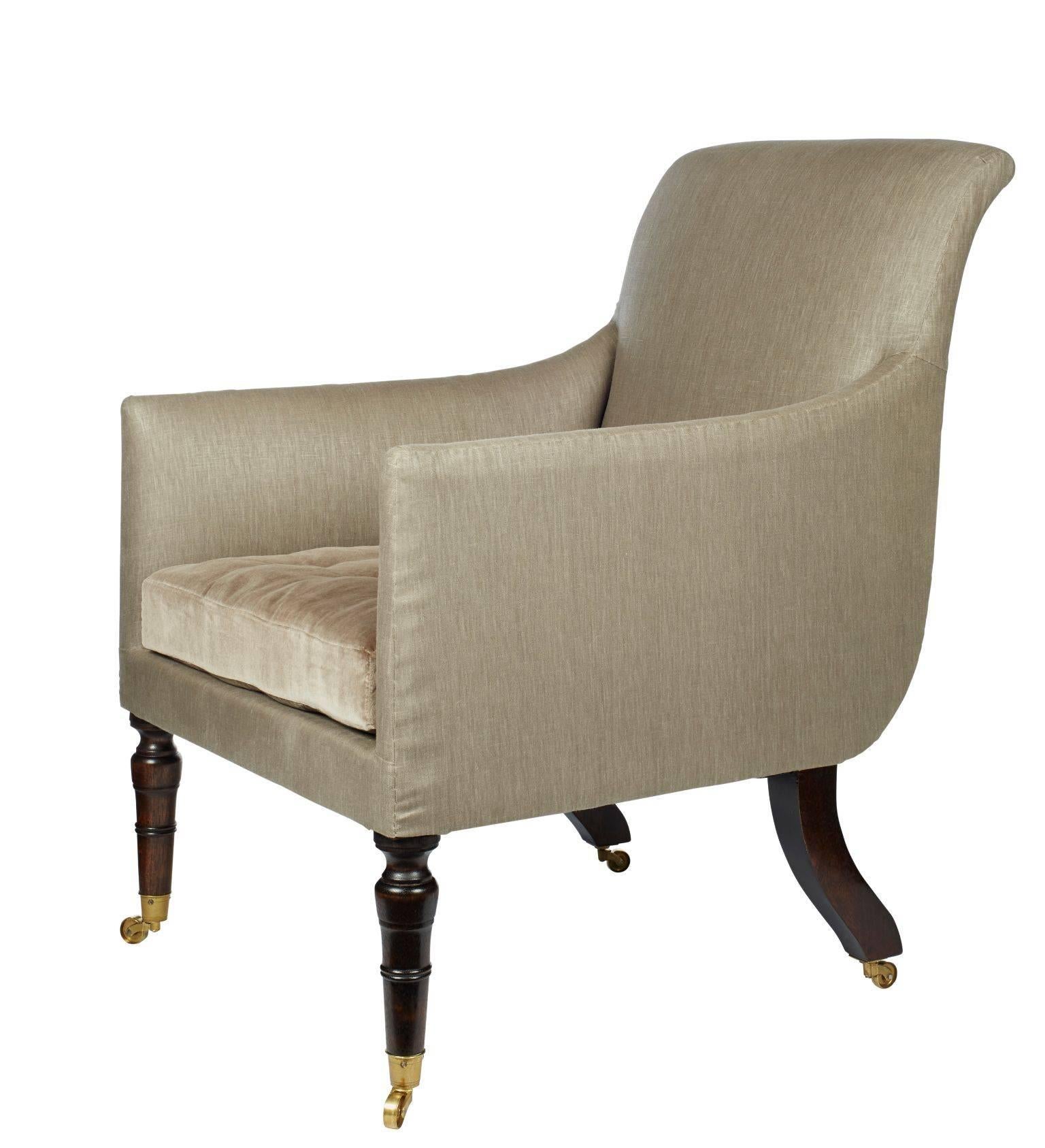 The Hope Library chair was inspired by an original Regency sabre-legged library chair. The armchair is customizable in fabric, detailing and legs. Featured image shows glazed linen and velvet, horsehair swab cushion with silk tufts and mahogany legs