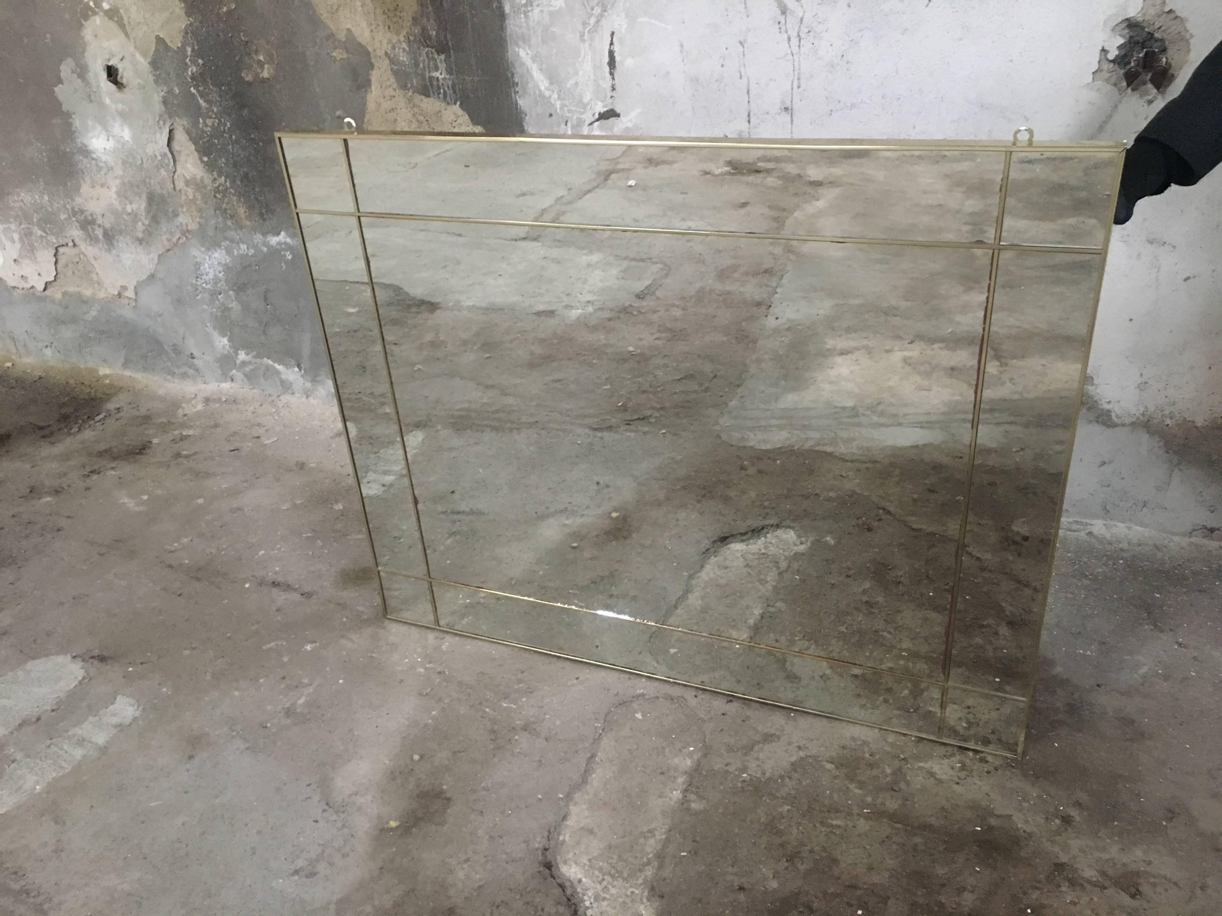Italian gilt metal framed mirror from 1970s
The mirror is in very good conditions and has gilt metal geometrical insert.