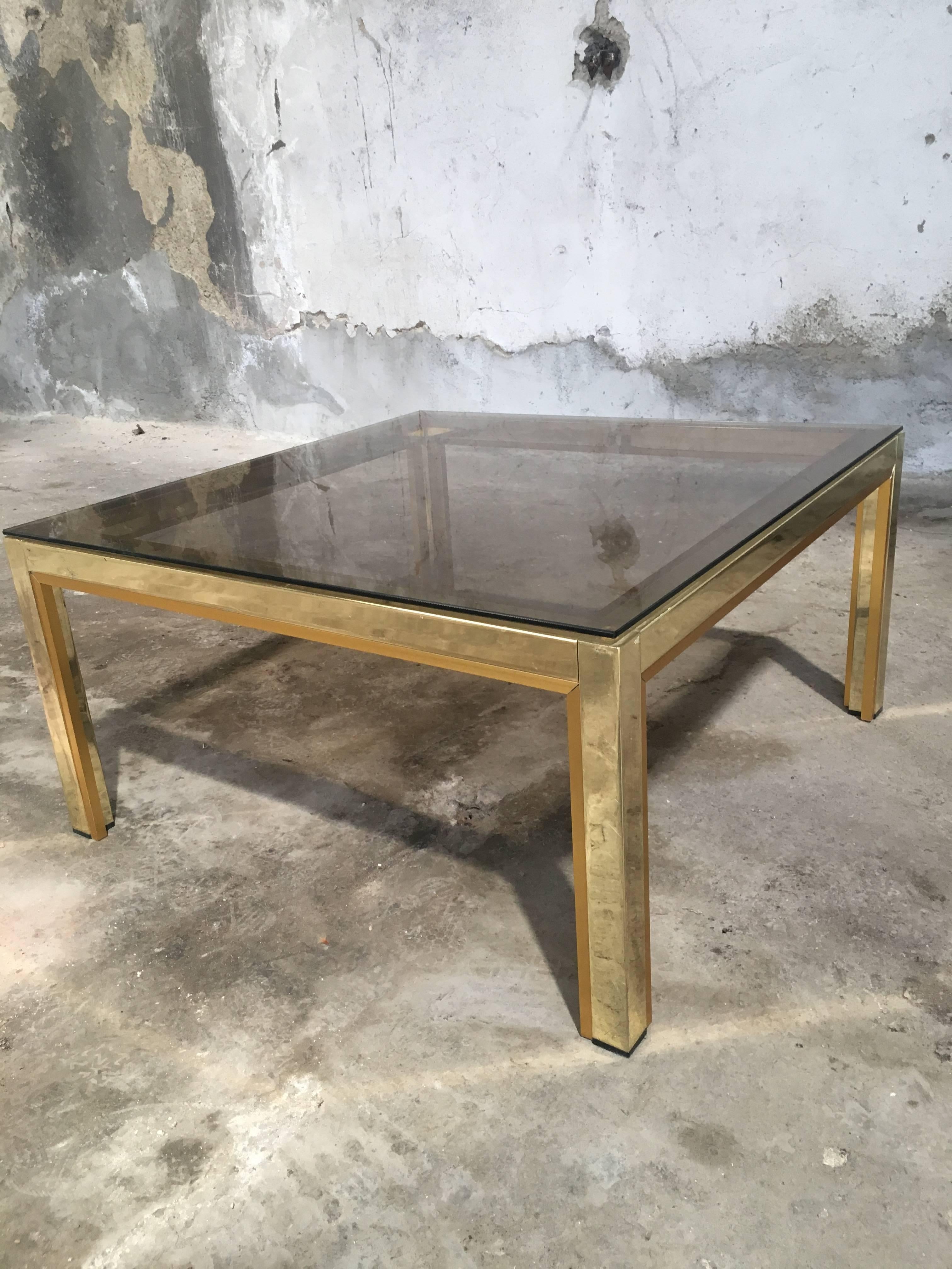 Italian 1970s brass and metal side or coffee table with smoked glass top
Measurements: cm.75 x 75 x H 38.