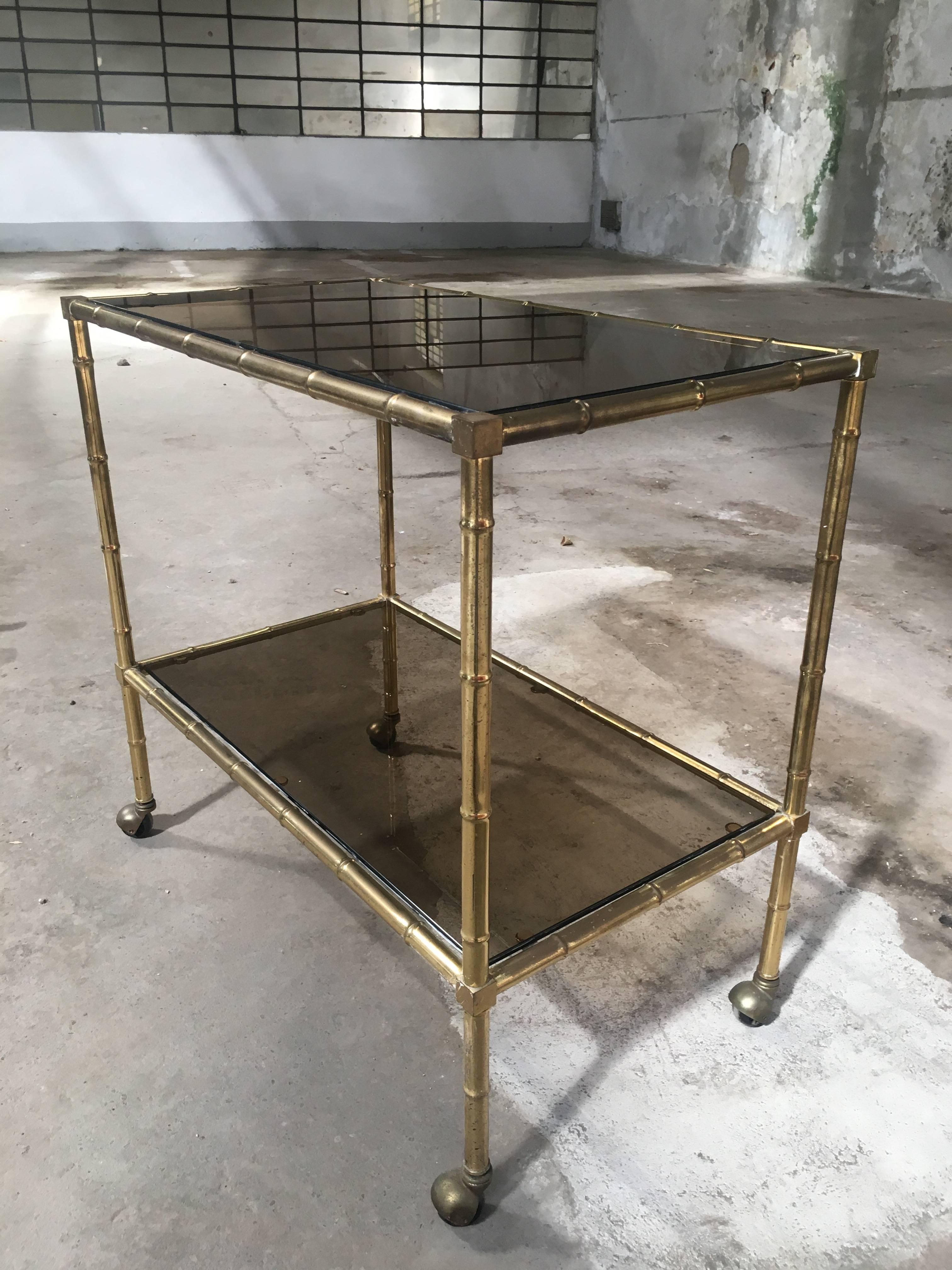 Mid-Century Modern Italian faux bamboo bar cart with smoked glasses.
