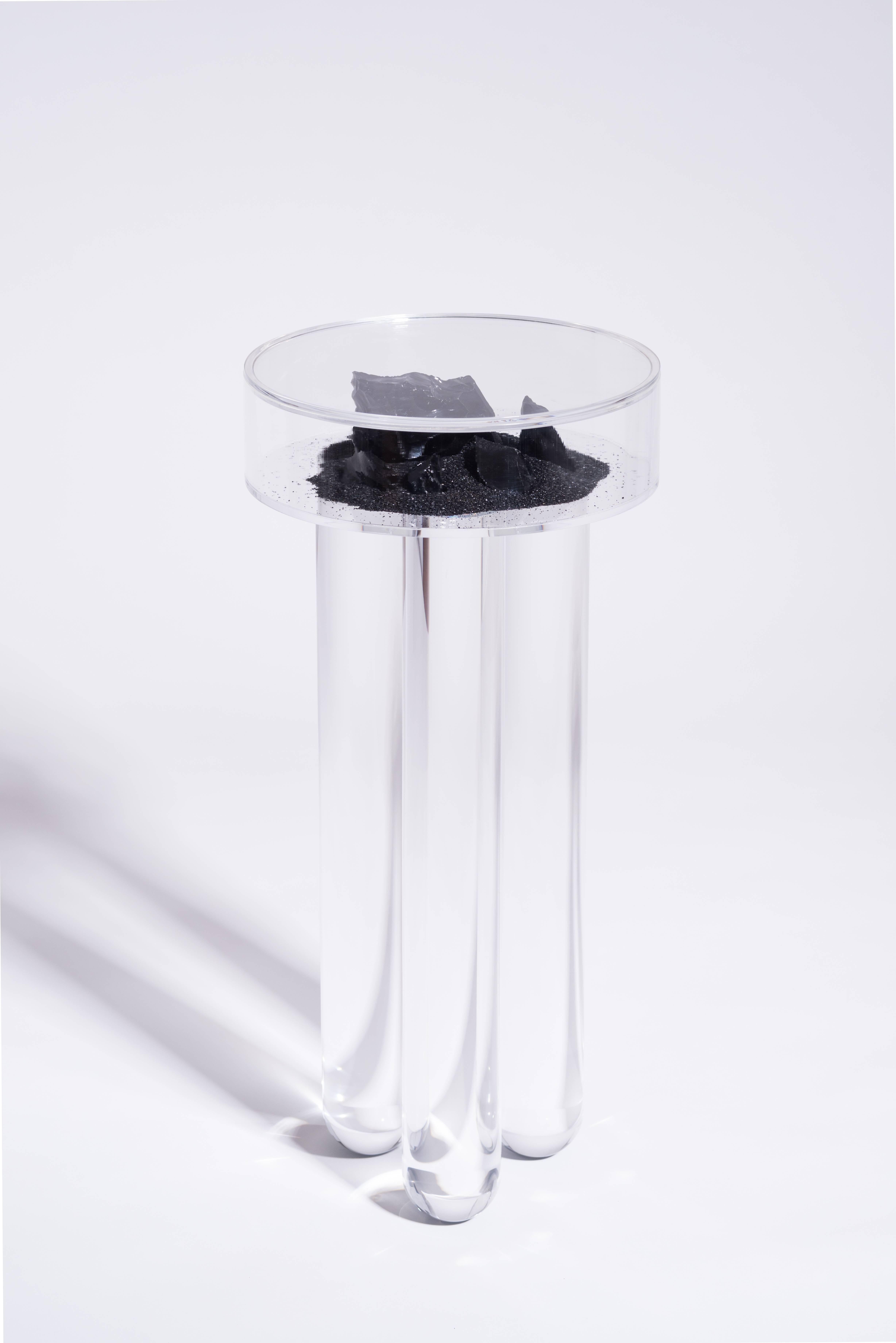 Juxtaposing beautiful natural minerals inside a man-made acrylic box, the Vacation table allows viewers to enjoy the souvenirs of going on a vacation without leaving their living room. The dark version carries black sand and Mexican obsidian, while