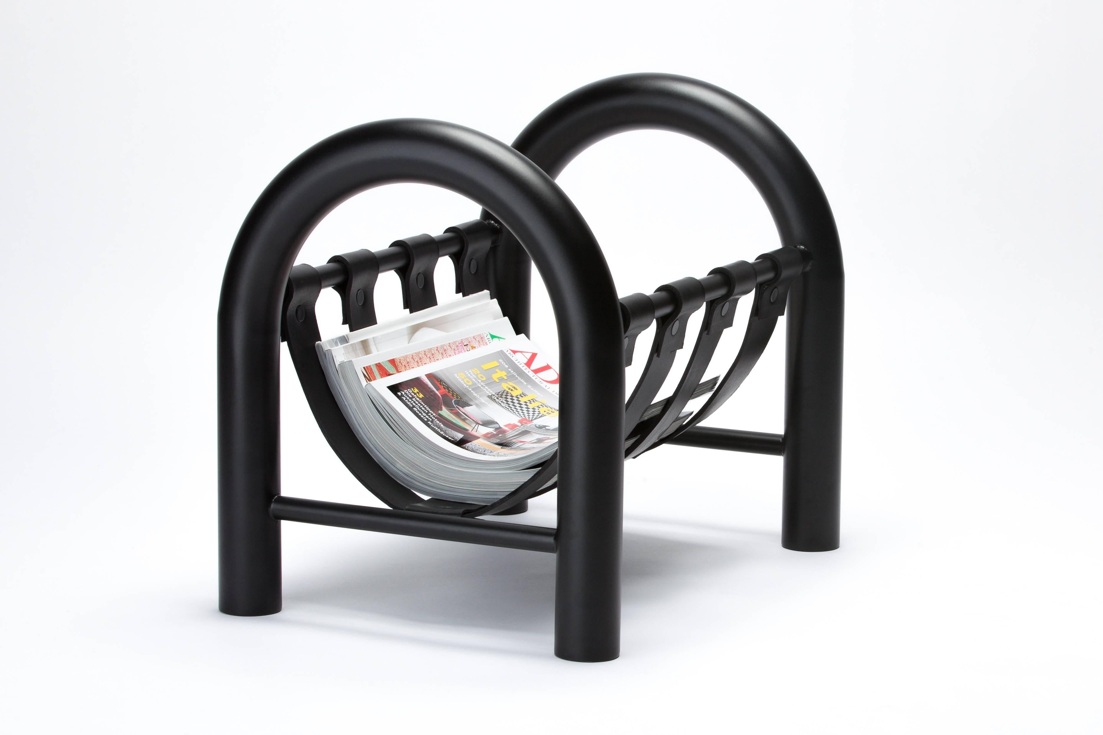 While the curves of the Tubular magazine rack are playful in form, the matte black finish and thick leather sling with black rivet detailing elevate the piece to a luxurious level. Tubular is a lightweight yet durable magazine rack perfect for