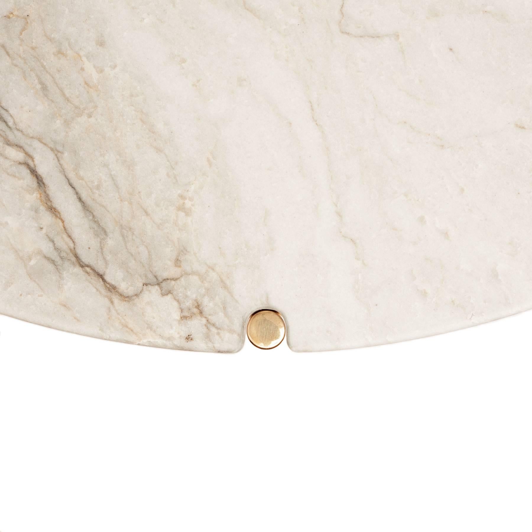 The CA32S entry table is defined by the subtle expression of its frame through notches pierced into its top. 

Available in several custom material and finish options - honed quartzite top / polished, unlacquered brass frame presented