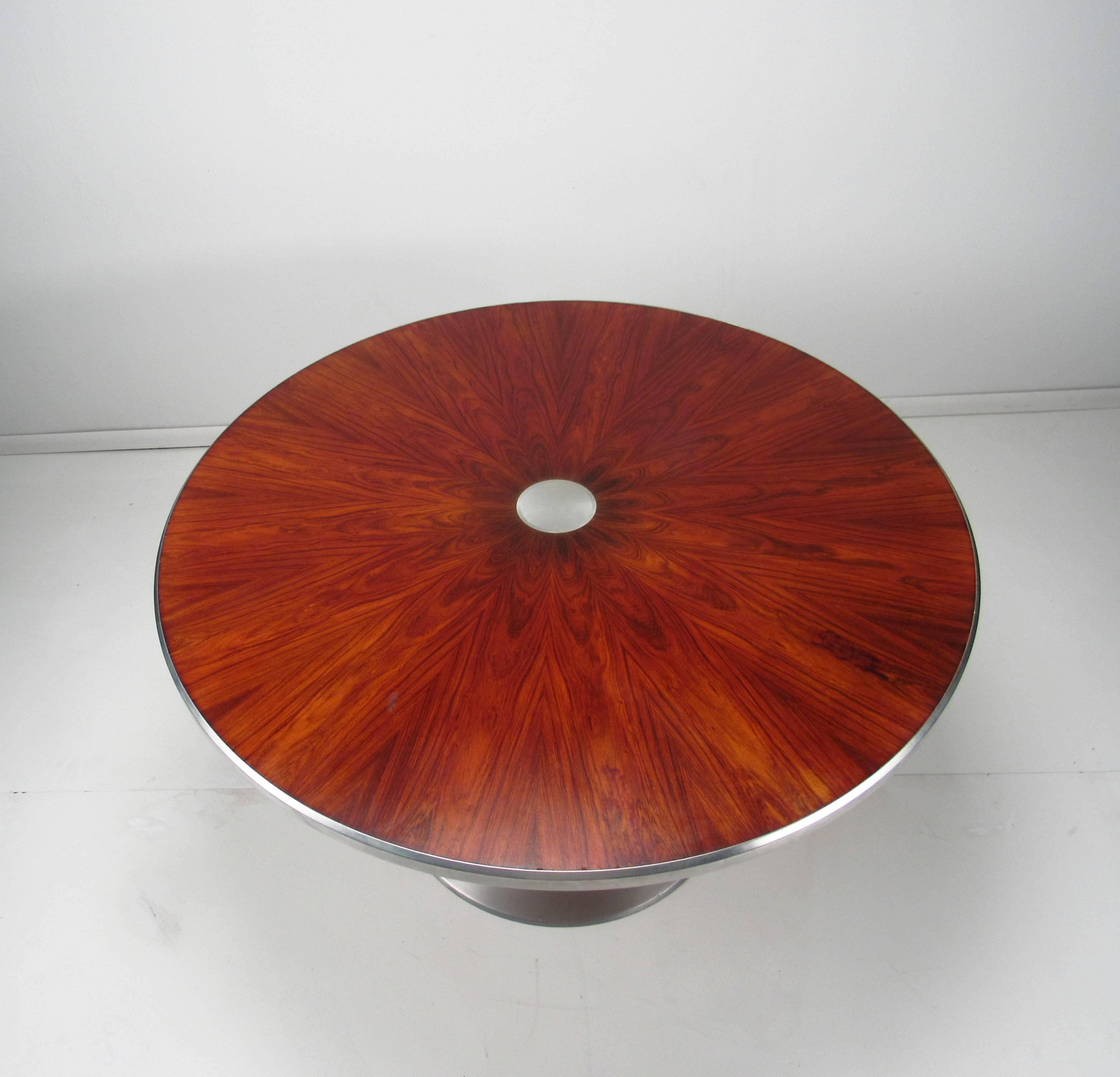 Poul Cadovius Rosewood and Aluminum Pedestal Table, circa 1970.  Rosewood Matched Top. Aluminium Trim. Polished Aluminum Pedestal. By Steen Ostergaard for Poul Cadovius, Denmark, circa 1970.
 
