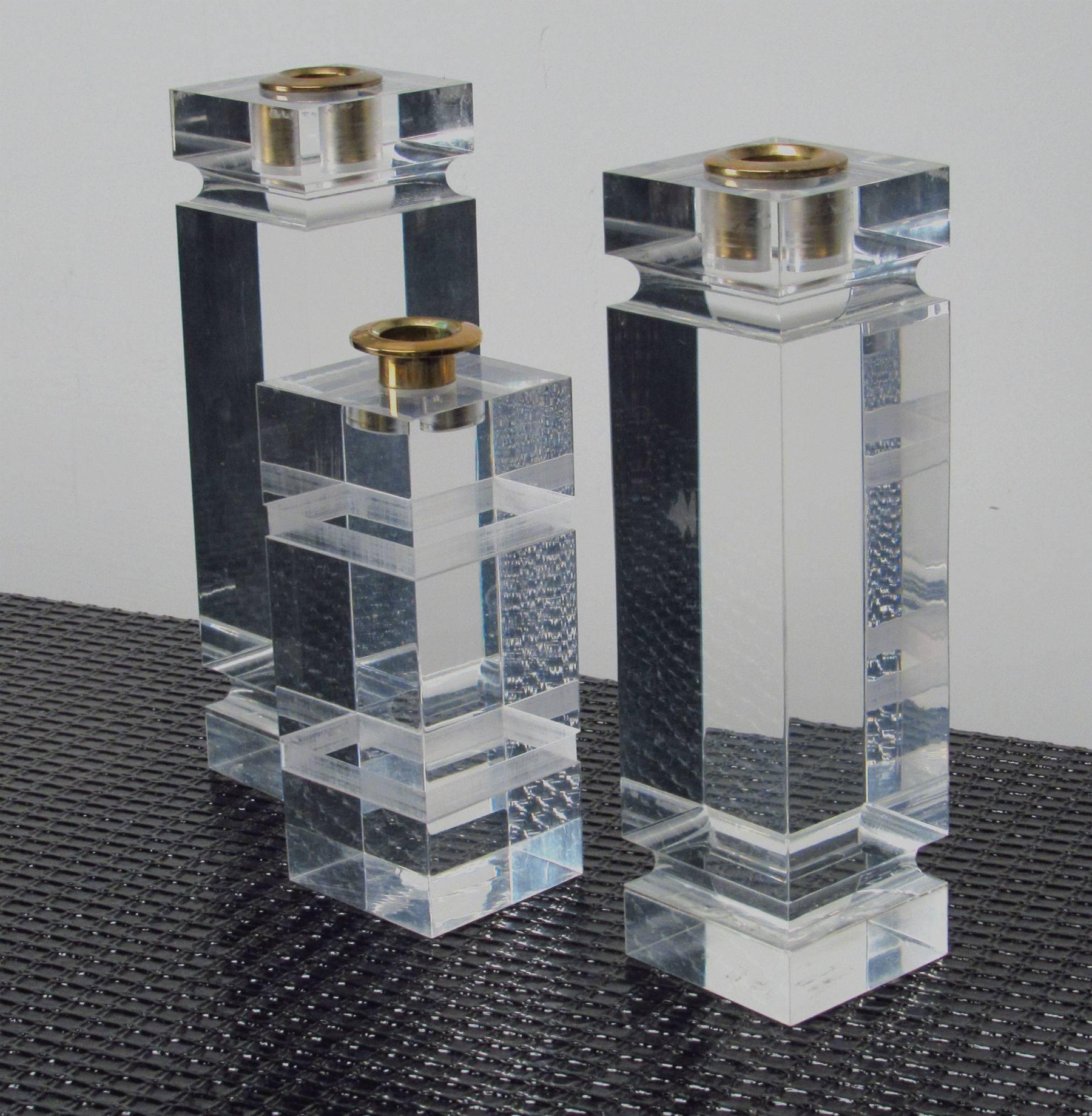 Set of 3 Three Lucite Candle Holders with Brass Inserts in the style of Charles Hollis Jones.  Circa 1980s
Dimensions: 
3