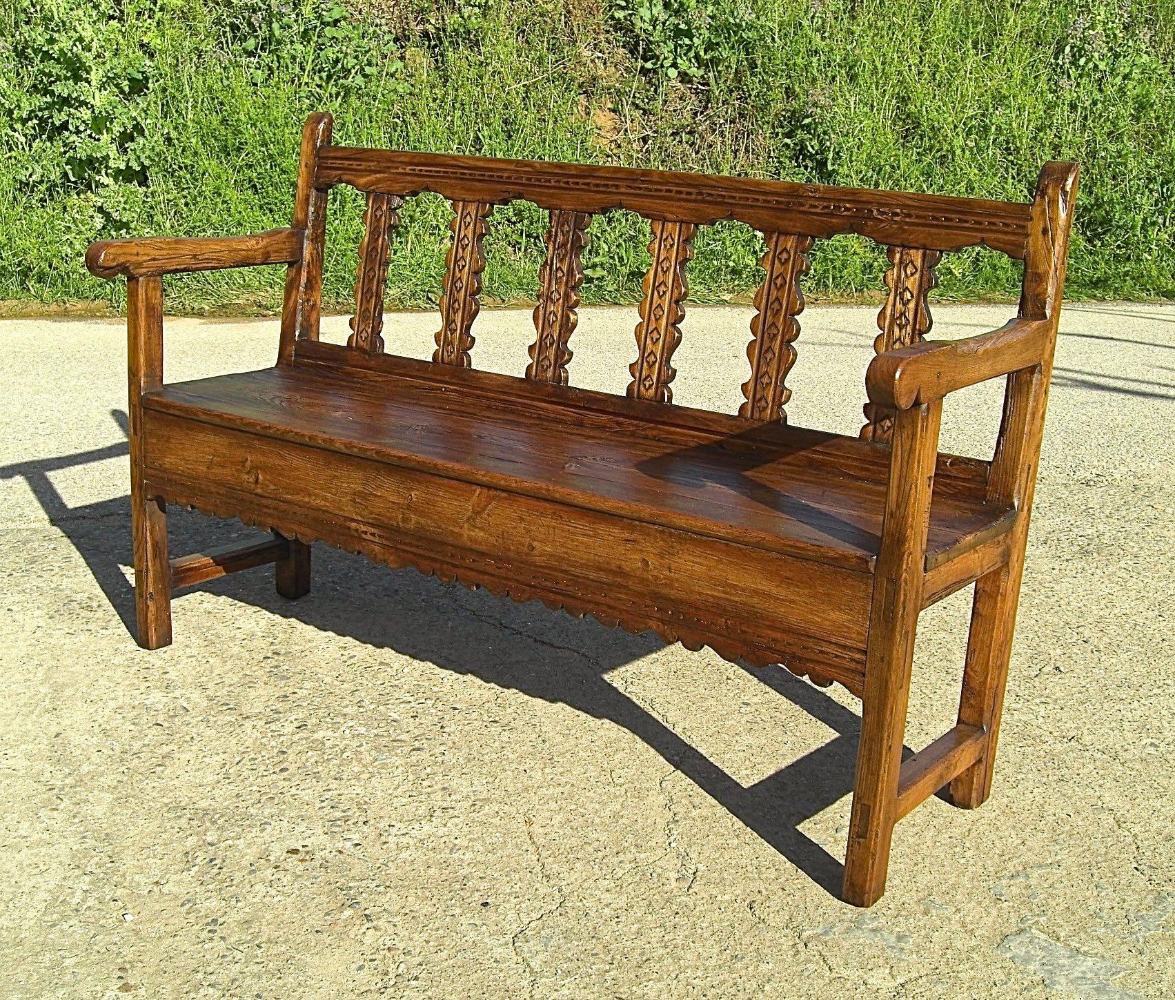 With phenomenal original patina, this matched pair of pine and elm benches was found in the Tena Valley in the Aragonese Pyrenees (province of Huesca, Spain). 

Crafted in the late 18th century, the pitched backs, splats, legs and arms of these