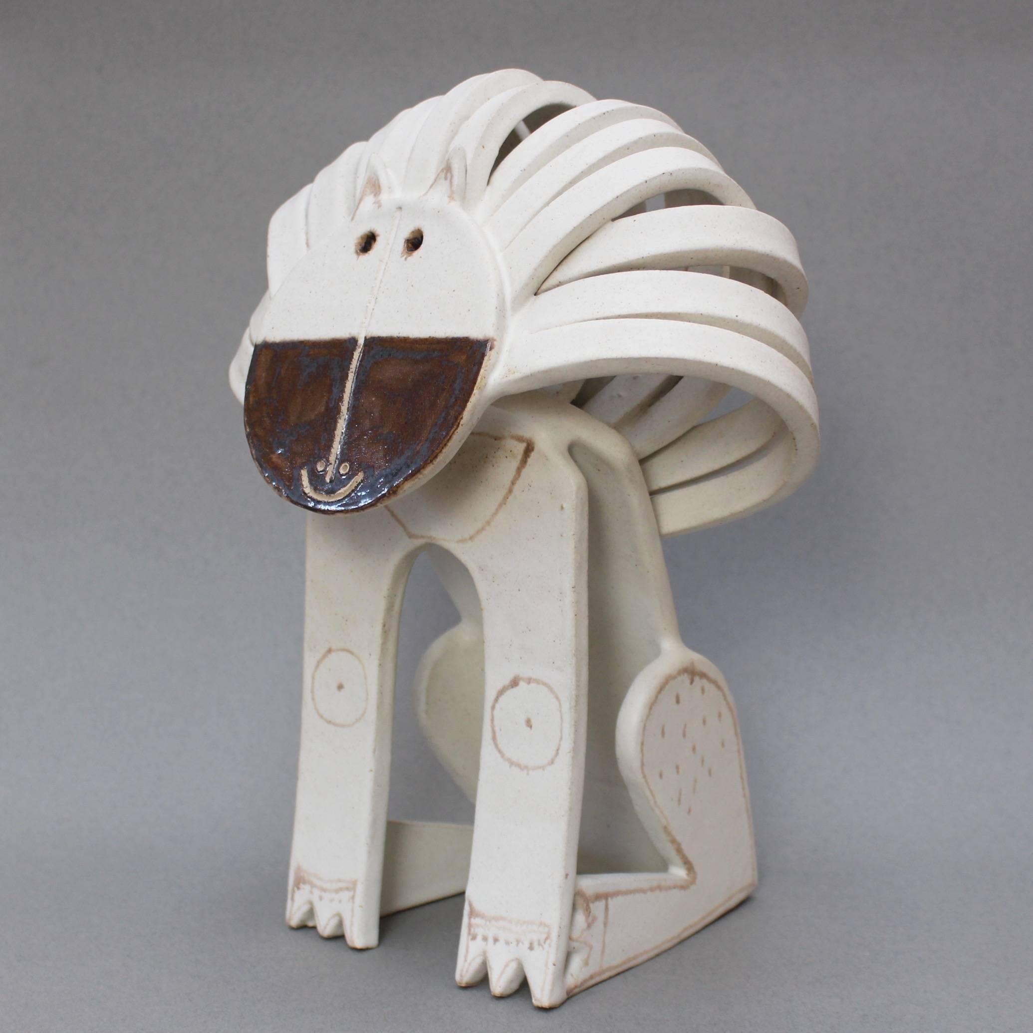 'Ceramic Lion Sculpture', by ceramicist Bruno Gambone, (circa 1970s). This large seated lion sculpture is truly a work of art. It is whimsical, yet beautiful in its use of the pared-down design elements associated with minimalism. Its chalk-white