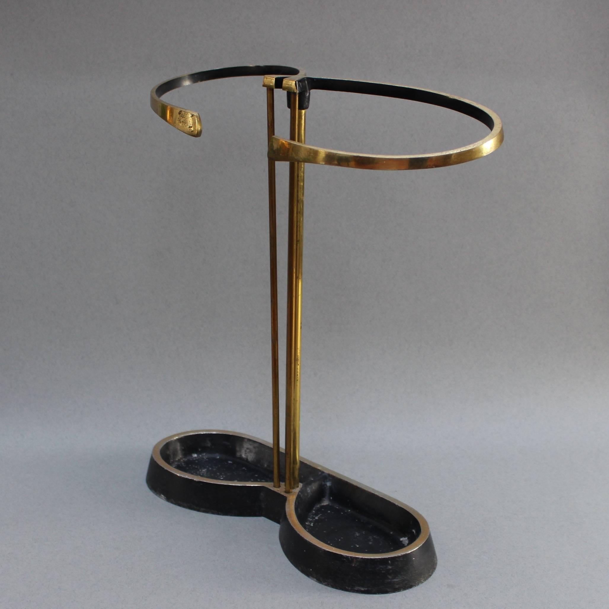 Cast iron and tubular brass umbrella stand from Austria, circa 1950s. Beautifully curvaceous design for those who love characterful midcentury vintage. This particular umbrella stand is showing distinctive signs of age and wear which add to its