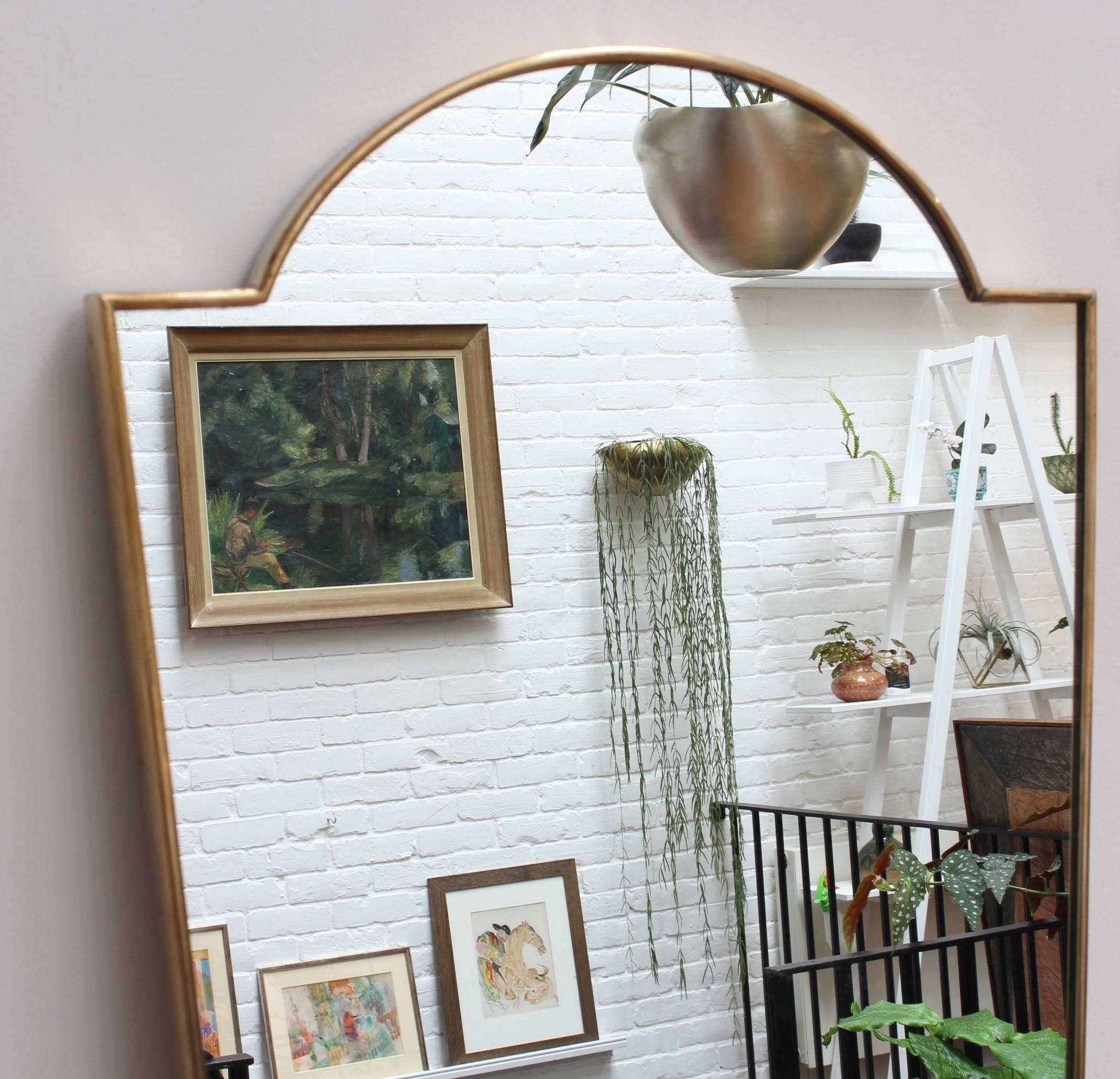 Midcentury Italian wall mirror with brass frame, circa 1950s. The mirror is lozenge-shaped classically elegant and distinctive in a modern Gio Ponti style. This mirror is in very good vintage condition. There are some evident but characterful