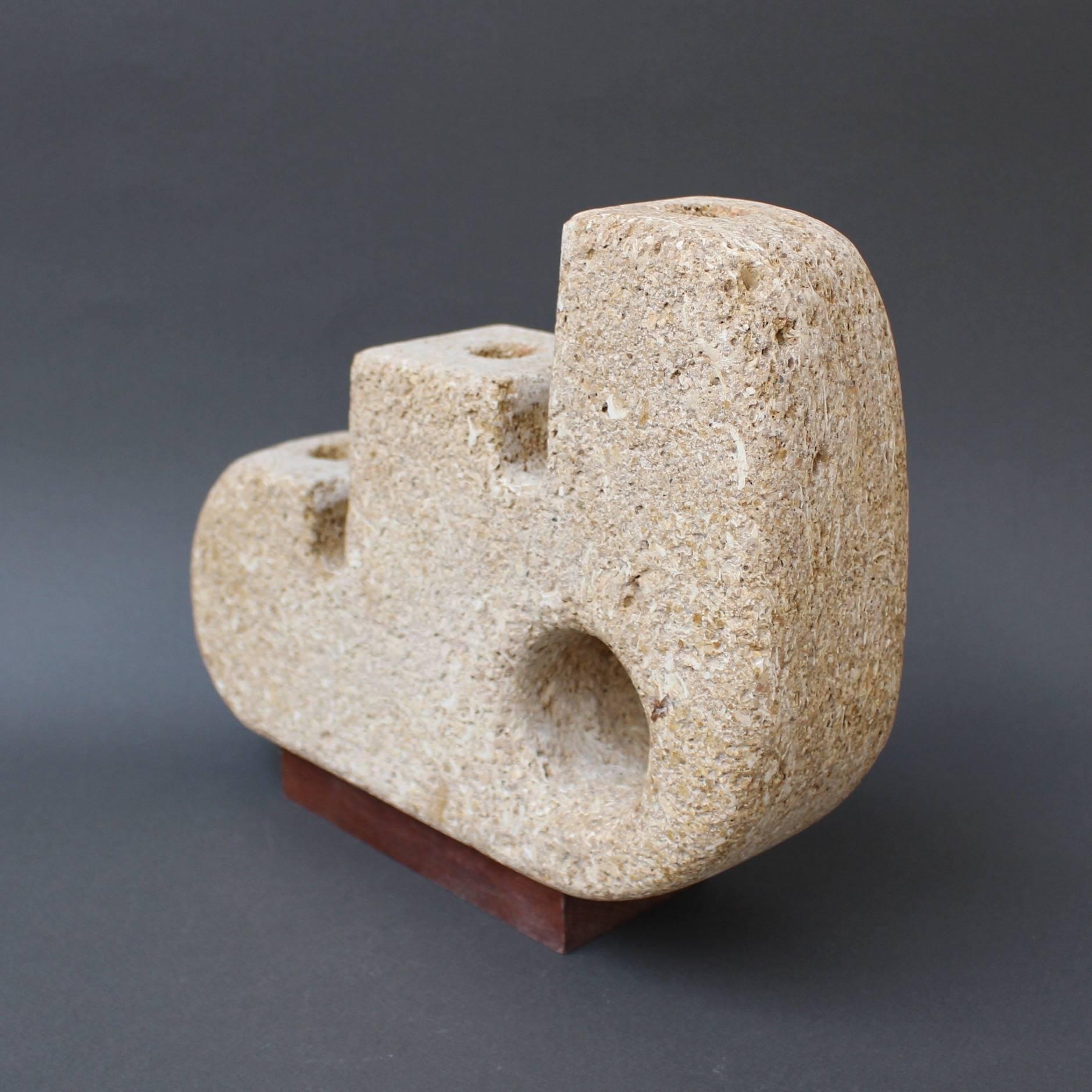 Limestone sculpted candle stand (circa 1970s). A weighty, Picasso-like, sculpted form with three descending levels with hollows to support candles. The limestone has retained its organic aspect created in nature from remains of marine life such as