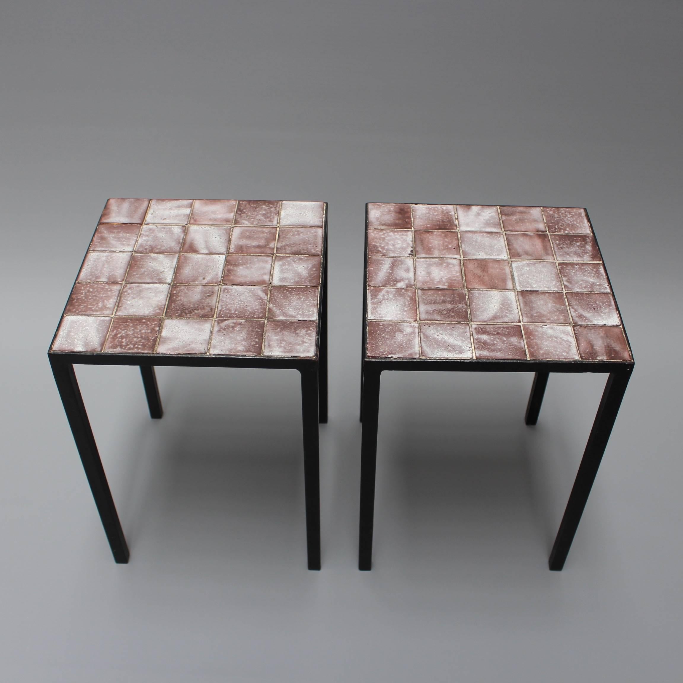 Set of two side tables perfectly simple and simply perfect. Ceramic tiles sit upon a frame and black metal legs in elegant symmetry. The tiles are of a brownish-purple base colour dusted with a textural white glaze - some are primarily