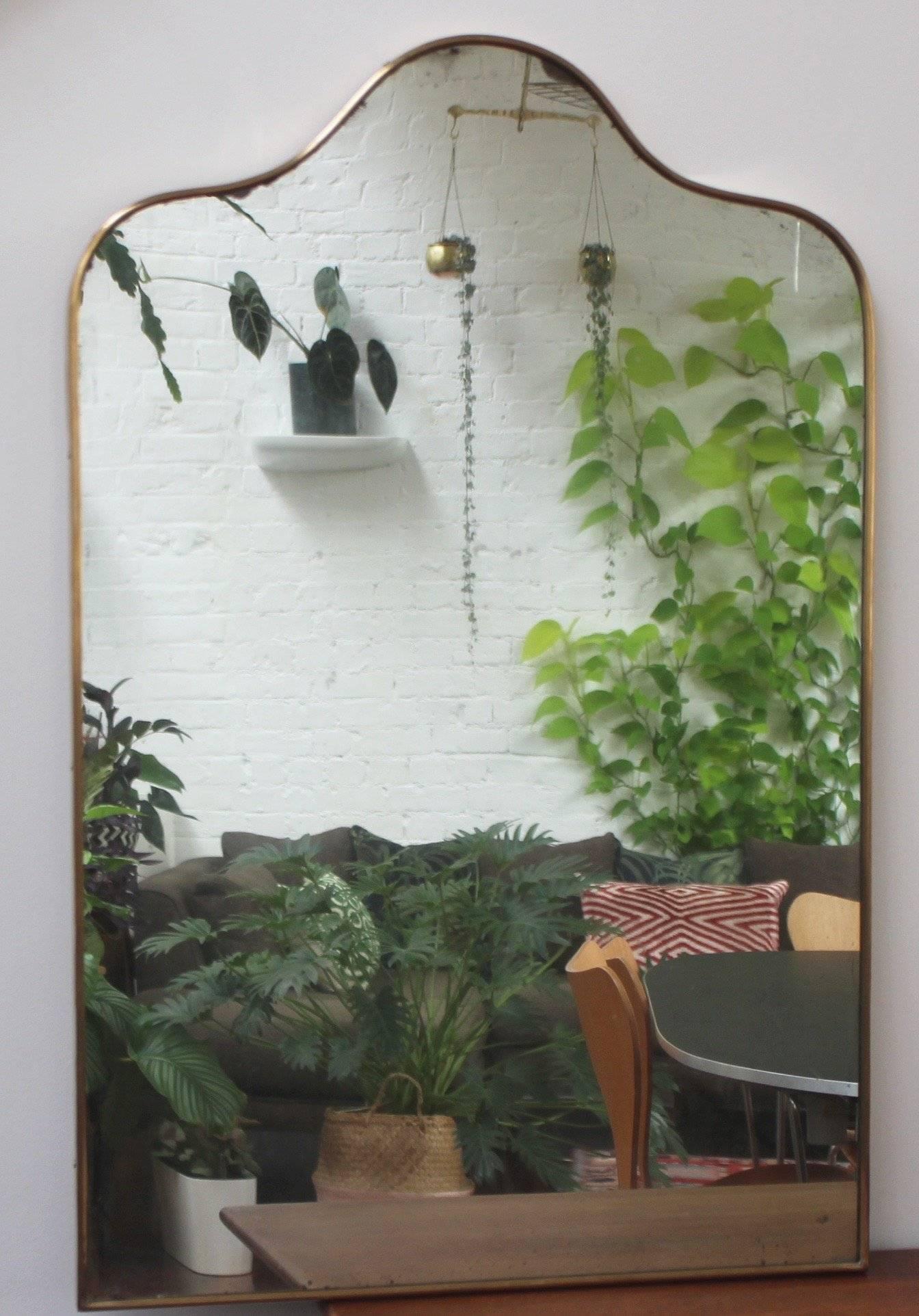 Mid-Century Italian wall mirror with brass frame, 1950s. This mirror is simply elegant and characterful in a modern Gio Ponti style. The mirror is in overall good condition with a new fitted backing. There are some evident black spots and blemishes