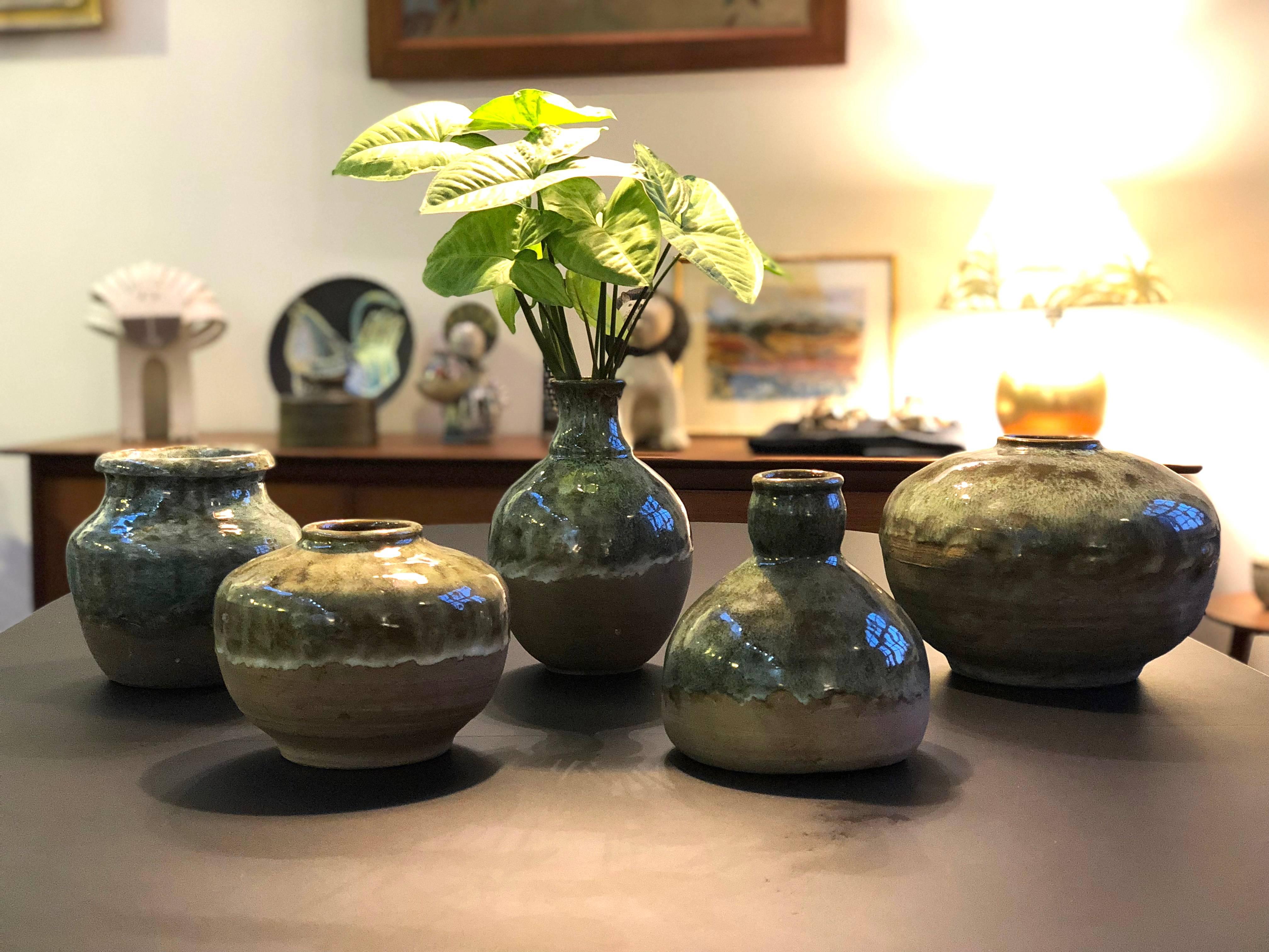 Mid-century Spanish ceramic collection by VF (circa 1960s). A collectible series of five beautiful Spanish ceramic vases and vessels. The tops of the pieces are with shiny glaze and drip effect over plane earthenware clay base. The contrast of the