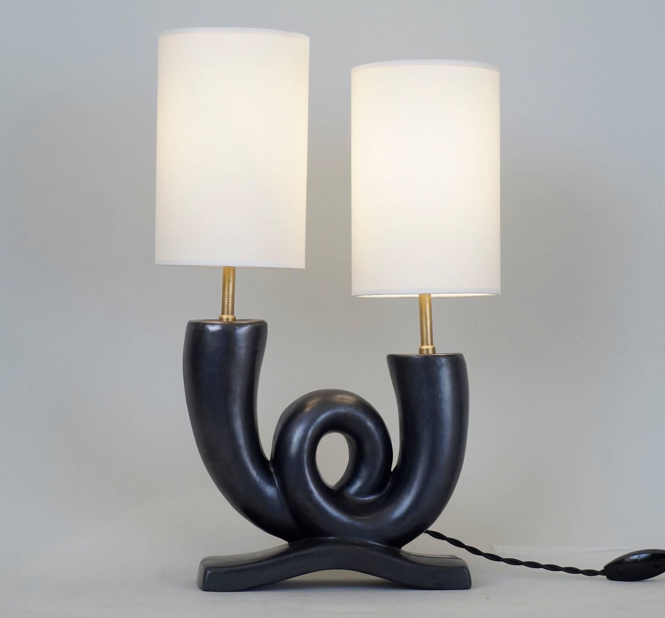 Table lamp in black satin ceramic.
Stamp on the back: Made in France.
Custom-made lampshade.
Rewired with twisted silk cord. 
US plug on request.
Ceramic height: 20 cm - 7.9in.
Height with lampshade: 41 cm - 16.1in.





