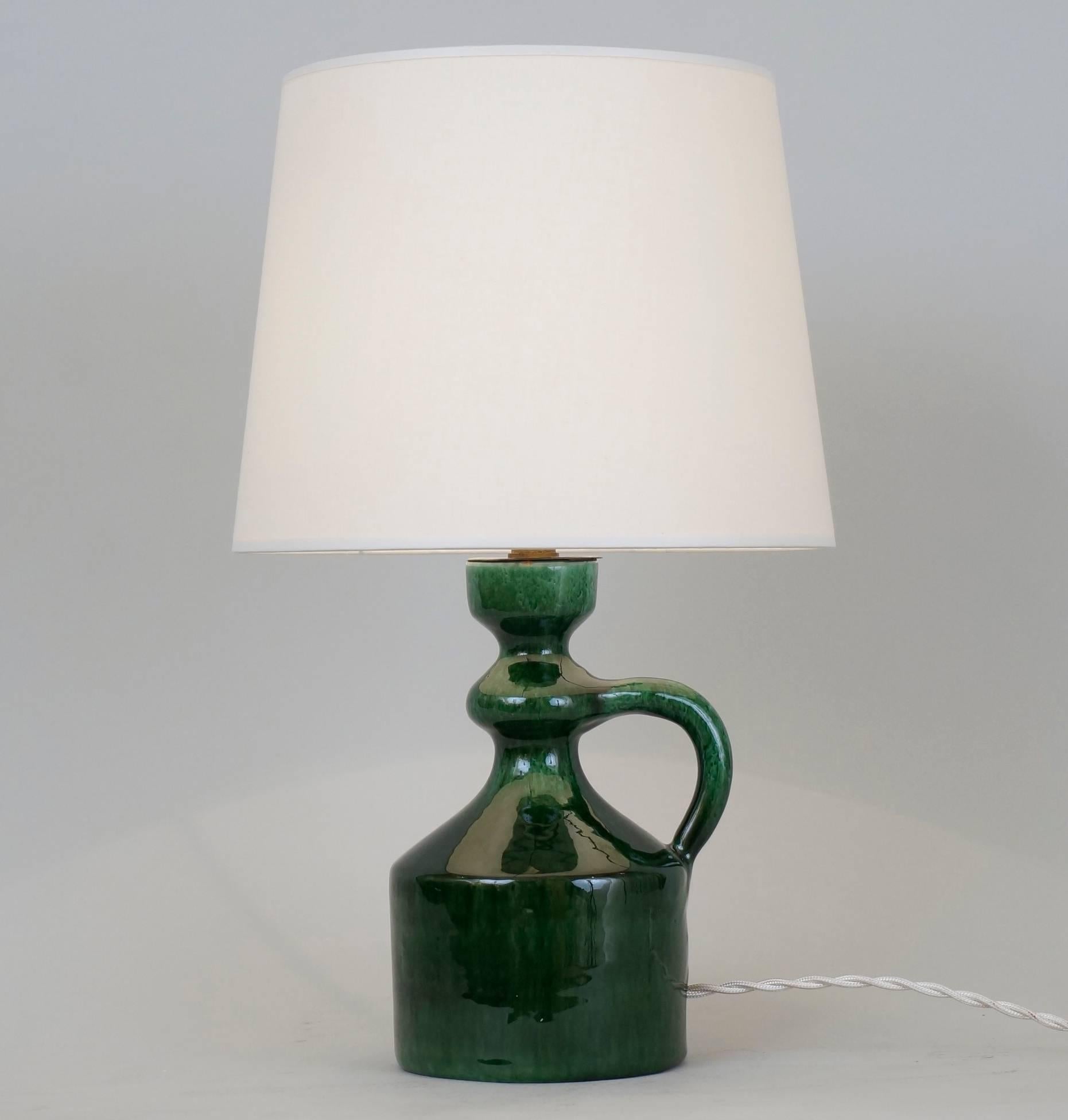 Green enameled ceramic table lamp by André Freymond signed on the back.
Custom-made lampshade.
Rewired with twisted silk cord.
US plug on request.
Measures: Ceramic height 19 cm - 7.5inches.
Height with lampshade: 36 cm - 14.2inches.

