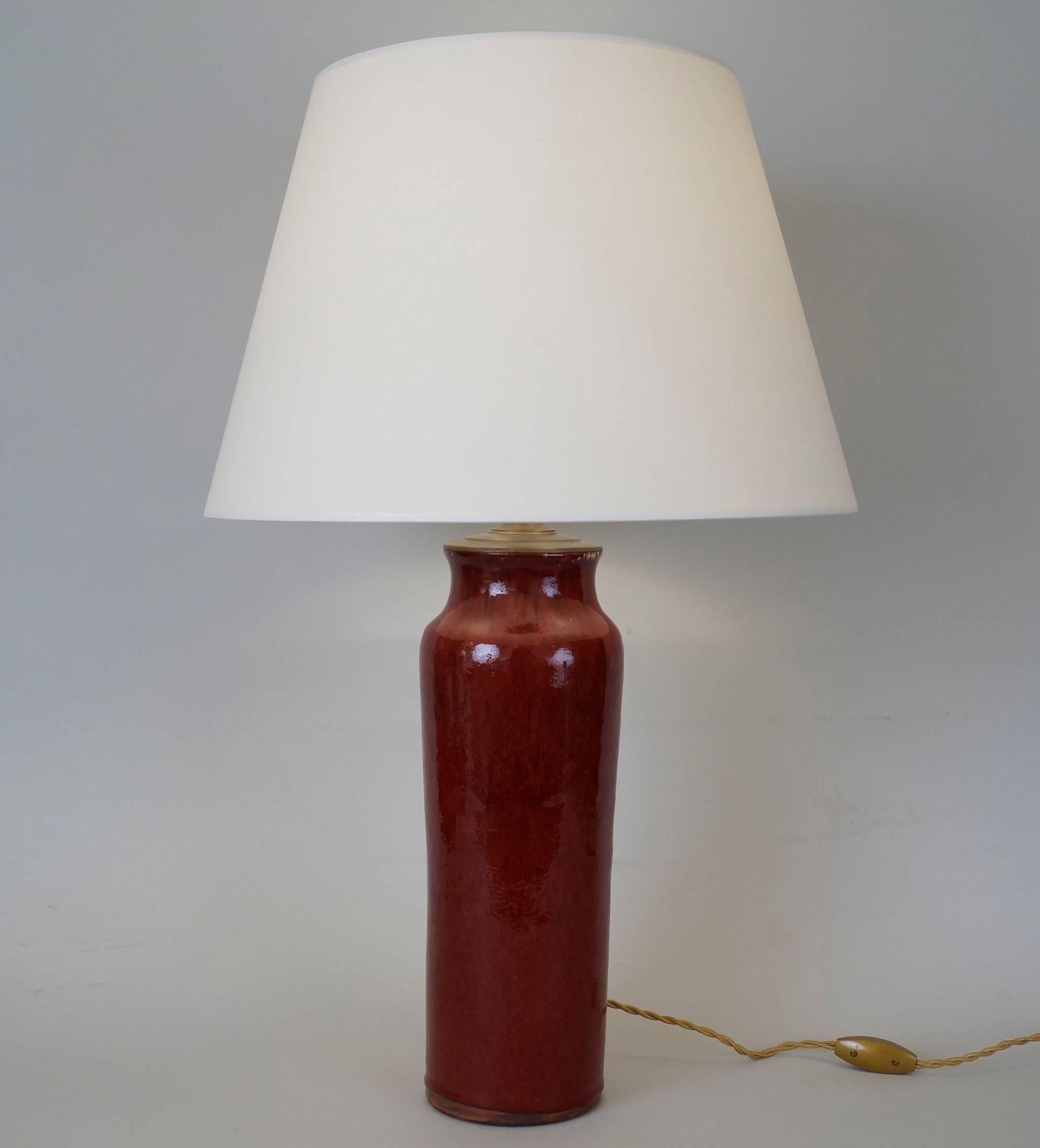 Oxblood red ceramic table lamp.
Adjustable height.
Custom-made fabric lampshade.
Rewired with twisted silk cord.
US standard plug on request.
Ceramic body height: 35 cm - 13.8 in.
Height with lampshade: 63 cm - 24.8 in.