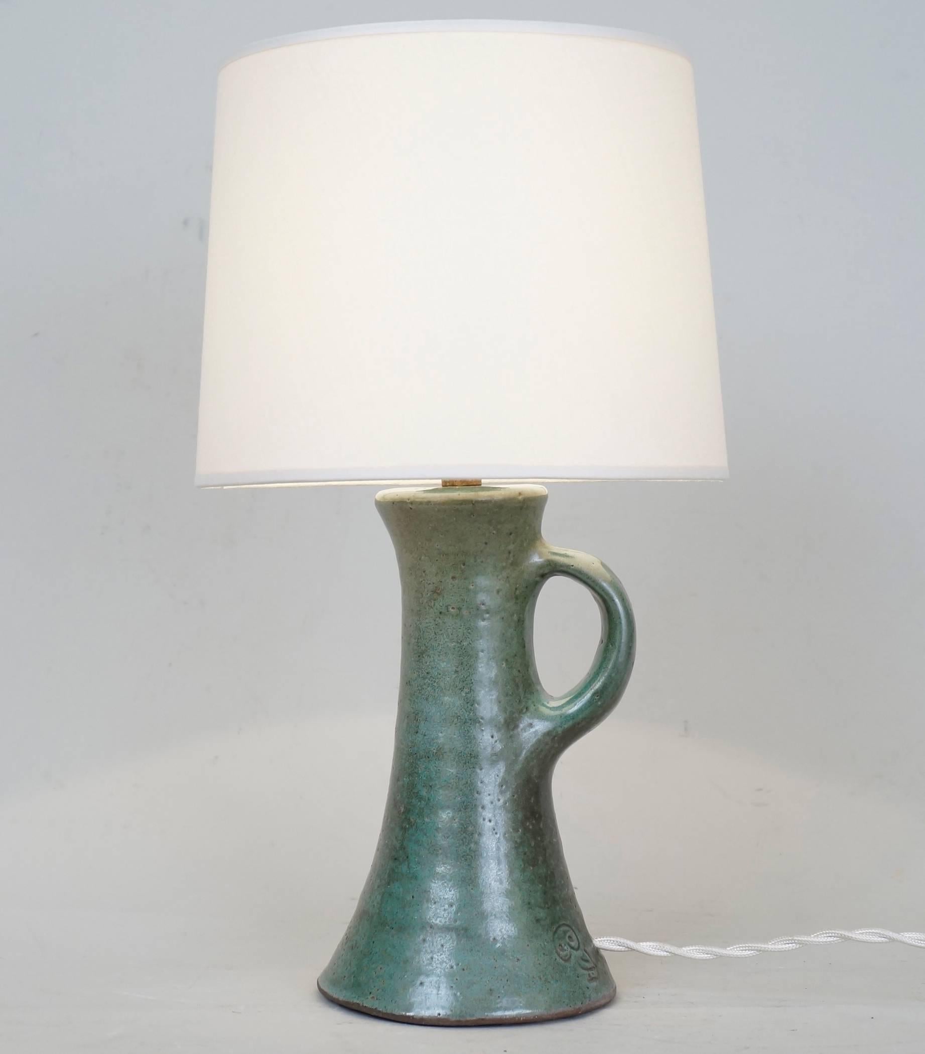Green ceramic table lamp by J&N Pierlot signed by the owl.
Custom-made fabric lampshade.
Rewired with twisted silk cord.
US standard plug on request.
Measures: Ceramic body height: 17 cm - 6.7 in.
Height with lampshade: 32 cm - 12.6 in.
  