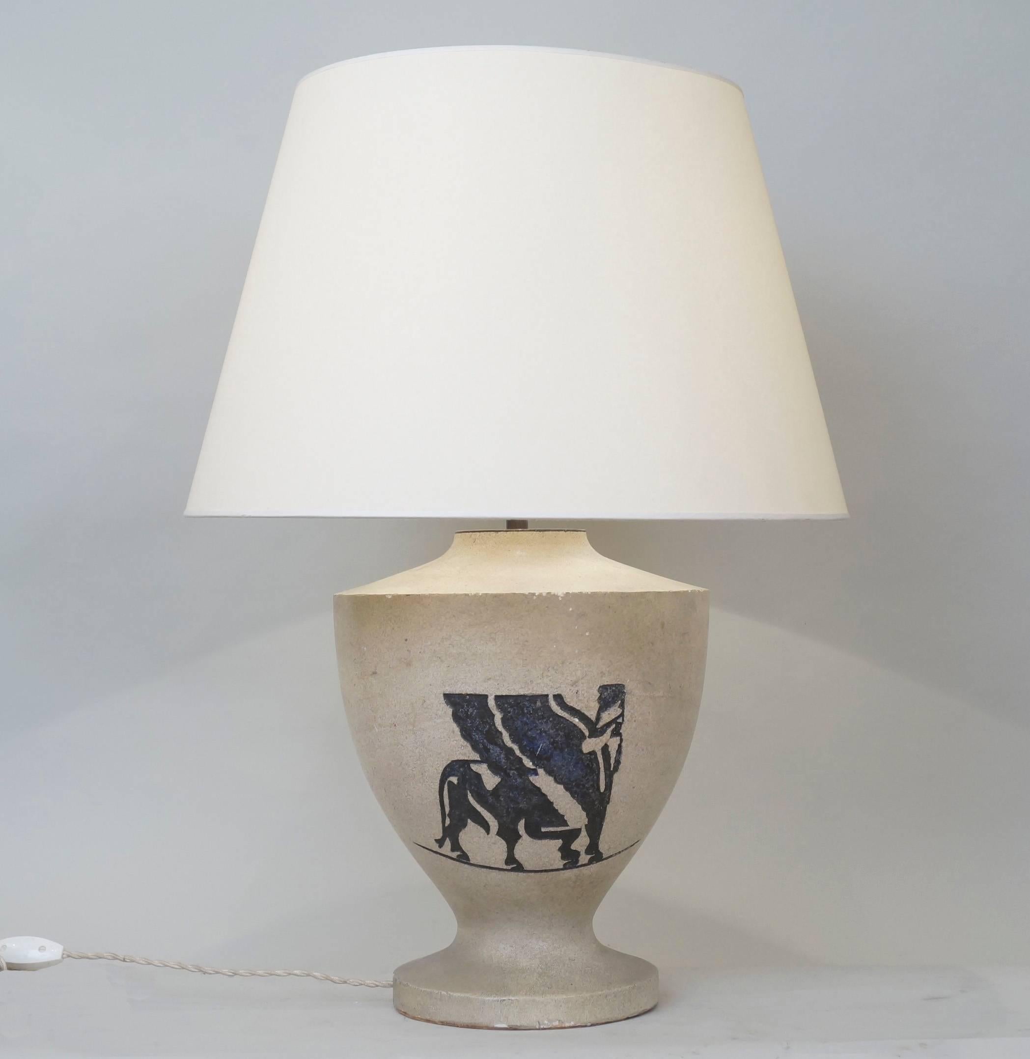 Midcentury stone table lamp with a chimeric engraved
Custom-made fabric lampshade.
Rewired with twisted silk cord.
US standard plug on request.
Measures: Ceramic body height: 32 cm - 12.6 in.
Height with lampshade: 64 cm - 25.2 in.

