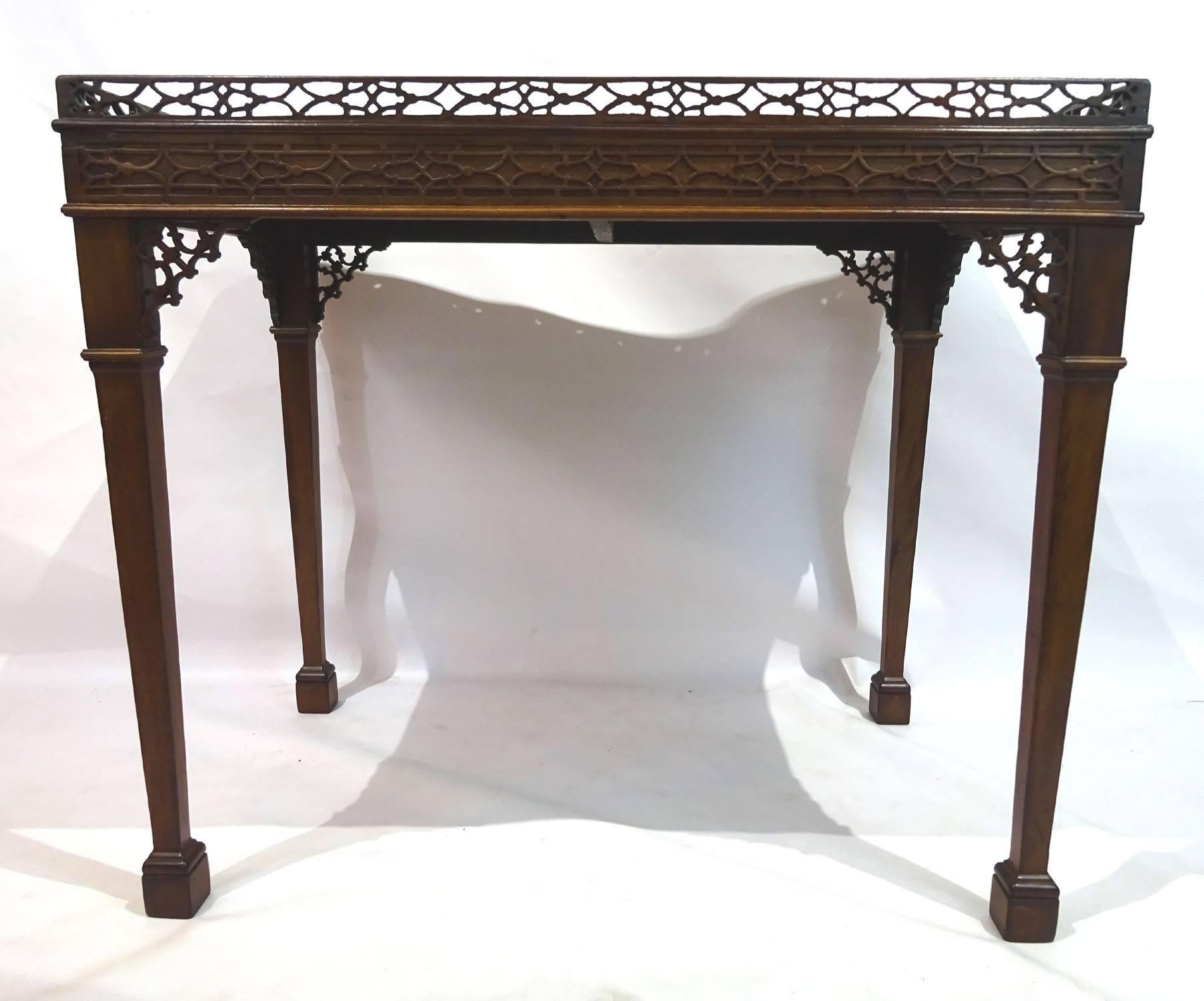 Early 19th century Victorian mahogany rectangular tea table with an open fretwork carved gallery over blind fretwork carved sides, with pull-out slide at each end, standing on four square tapered legs with block feet.
