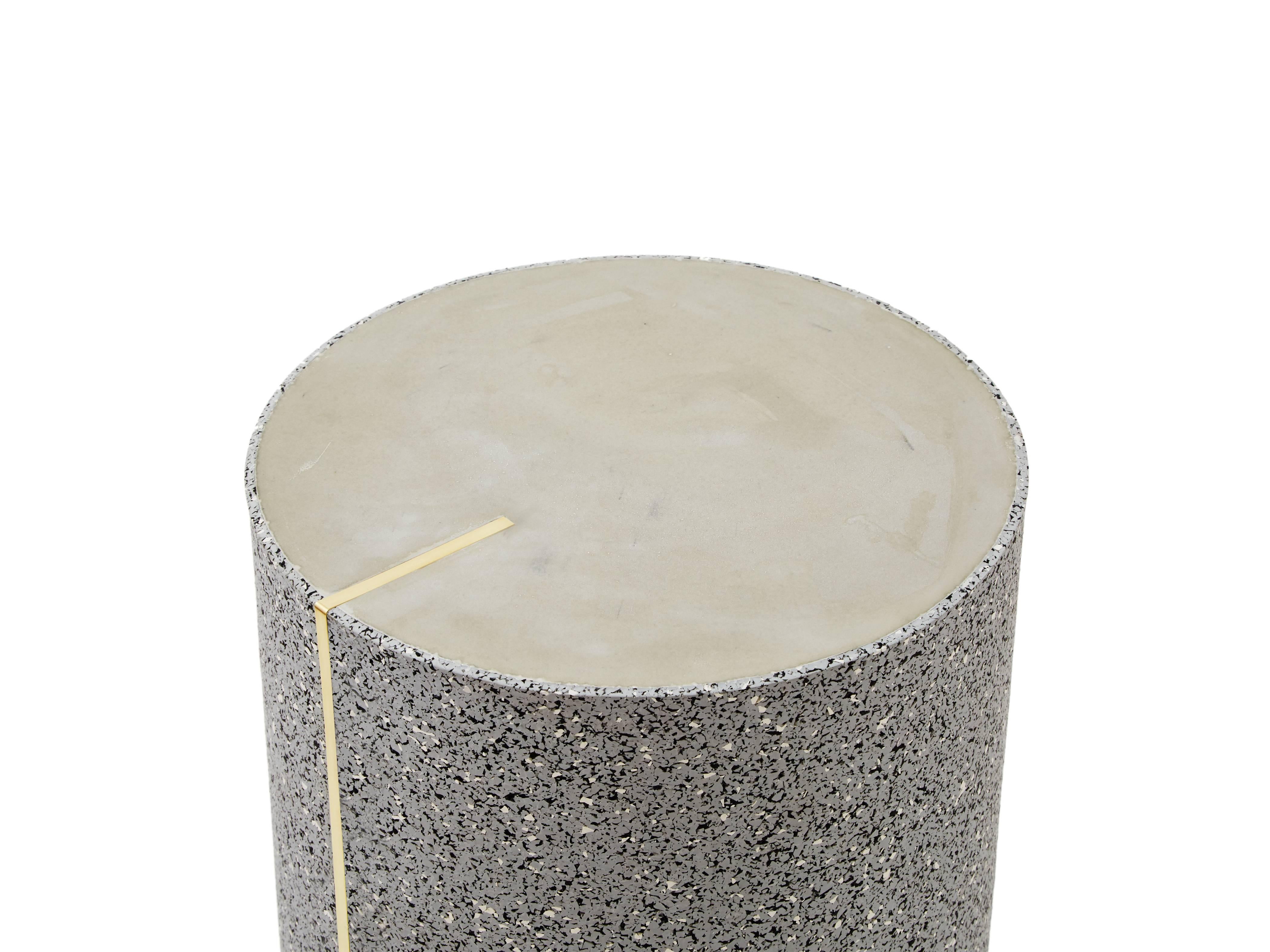 Rubber and concrete side table with a brass inlay created by Slash Objects

Materials: Rubber exterior in gris, concrete surface, brass inlay.

Dimensions: 12/18 inches.
 