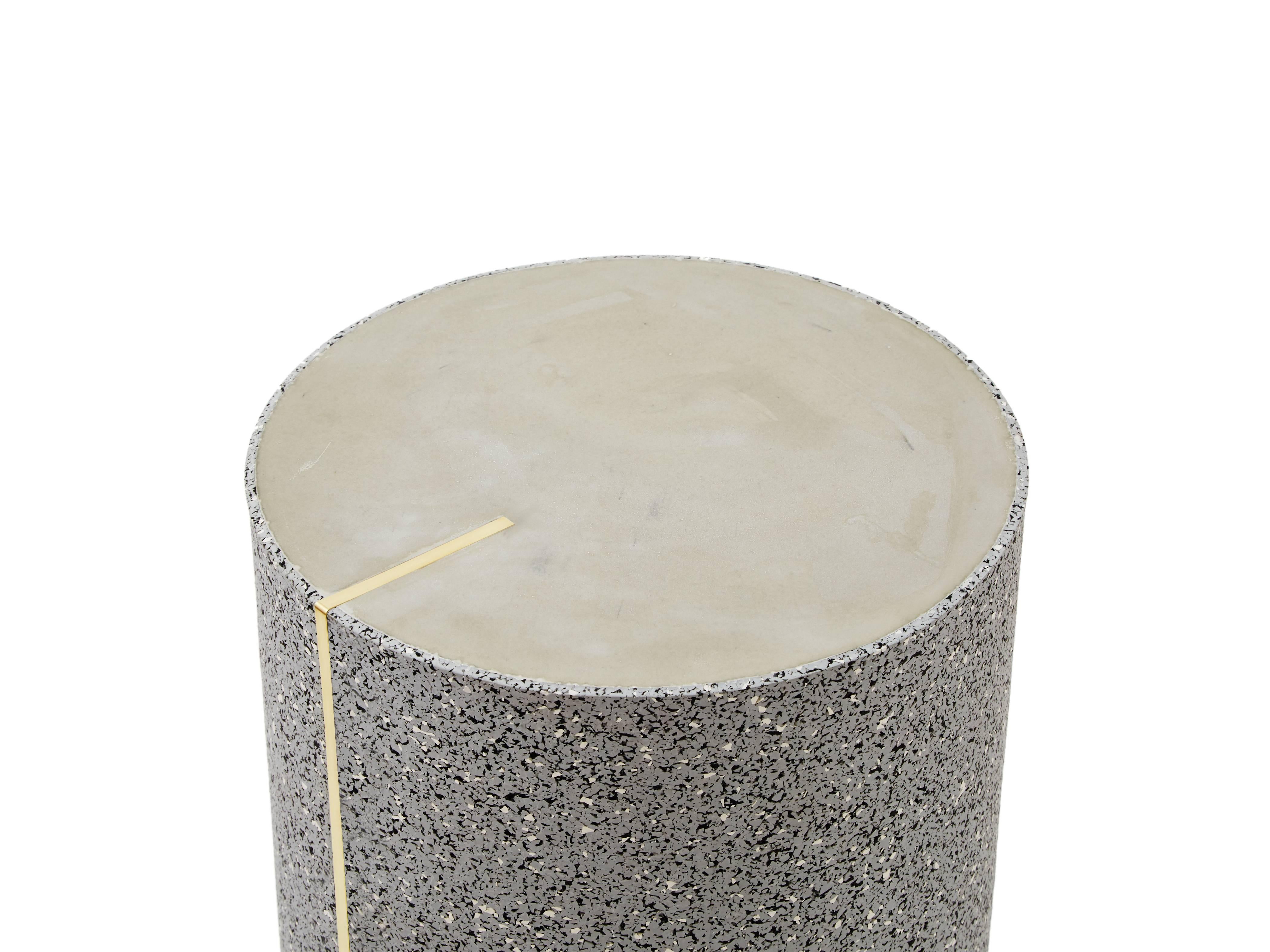 Rubber and concrete side table with a brass inlay created by Slash Objects

Materials: Rubber exterior in Gris, concrete surface, and brass inlay

Dimensions: 12/18 inches.
 