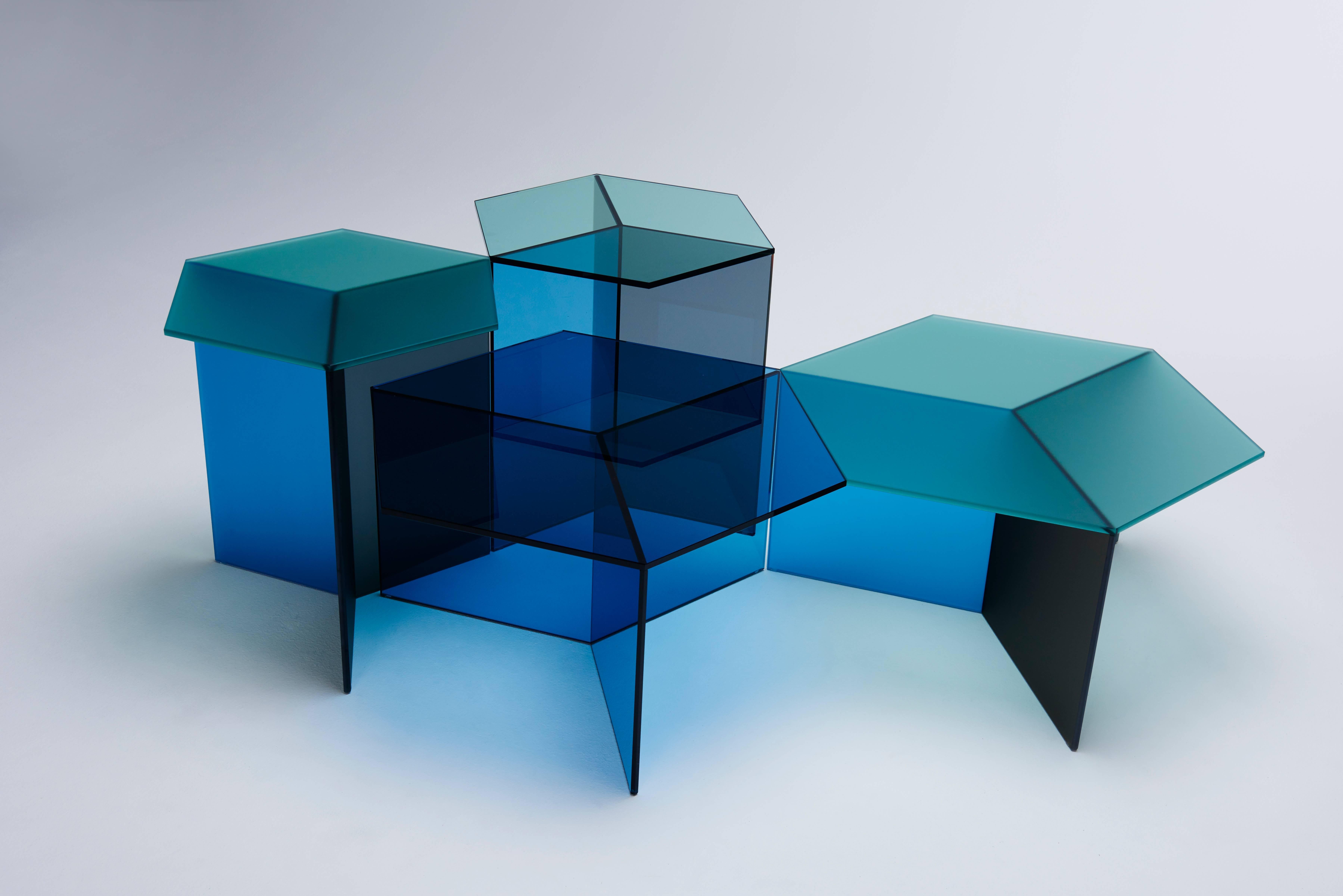 The Isom side tables create intriguing optical illusions, conjuring images of isometric cubes when viewed from certain angles. This effect is created through the CNC processing of traditional plate glass combined with a millimetre-precise bonding